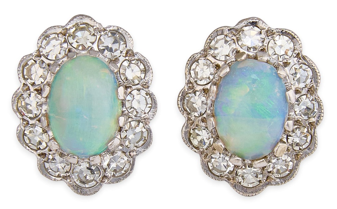 Red McCombs | 14K Opal Diamond Earrings: Pair of 14K white gold earrings set with opal oval cabochons, framed with halo of bezel-set round brilliant-cut diamonds, with pierced post clutches Size: 12 mm x 9 mm Total weight: 3.2 g Provenance: 