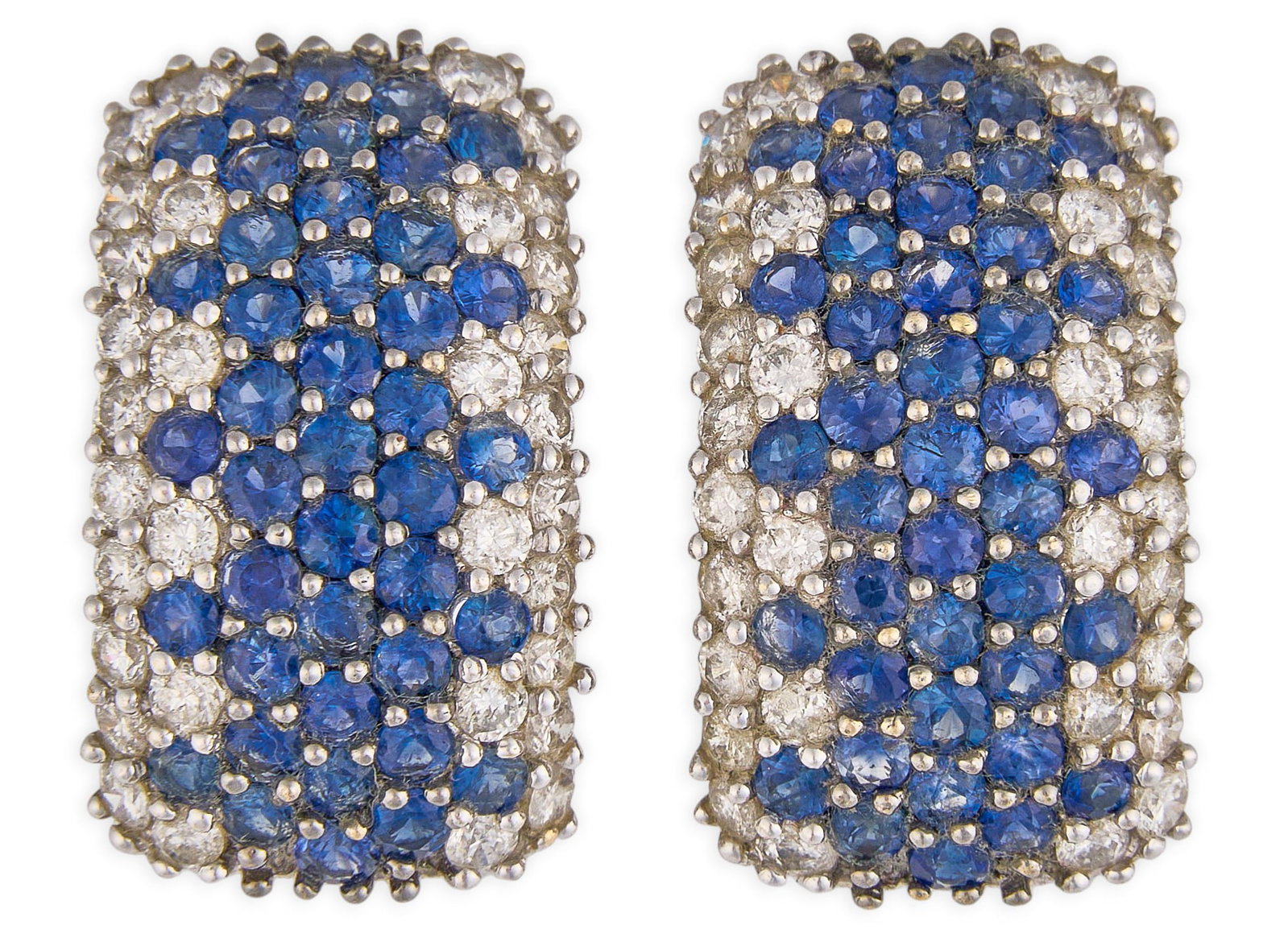 Red McCombs | 18K Sapphire Diamond Huggie Earrings: Pair of 18K white gold half hoop earrings, with bead-set round brilliant-cut diamonds and sapphires, marked "18K 750" Size: 7/8 in. / length Total weight: 11.5 g Provenance: Proper