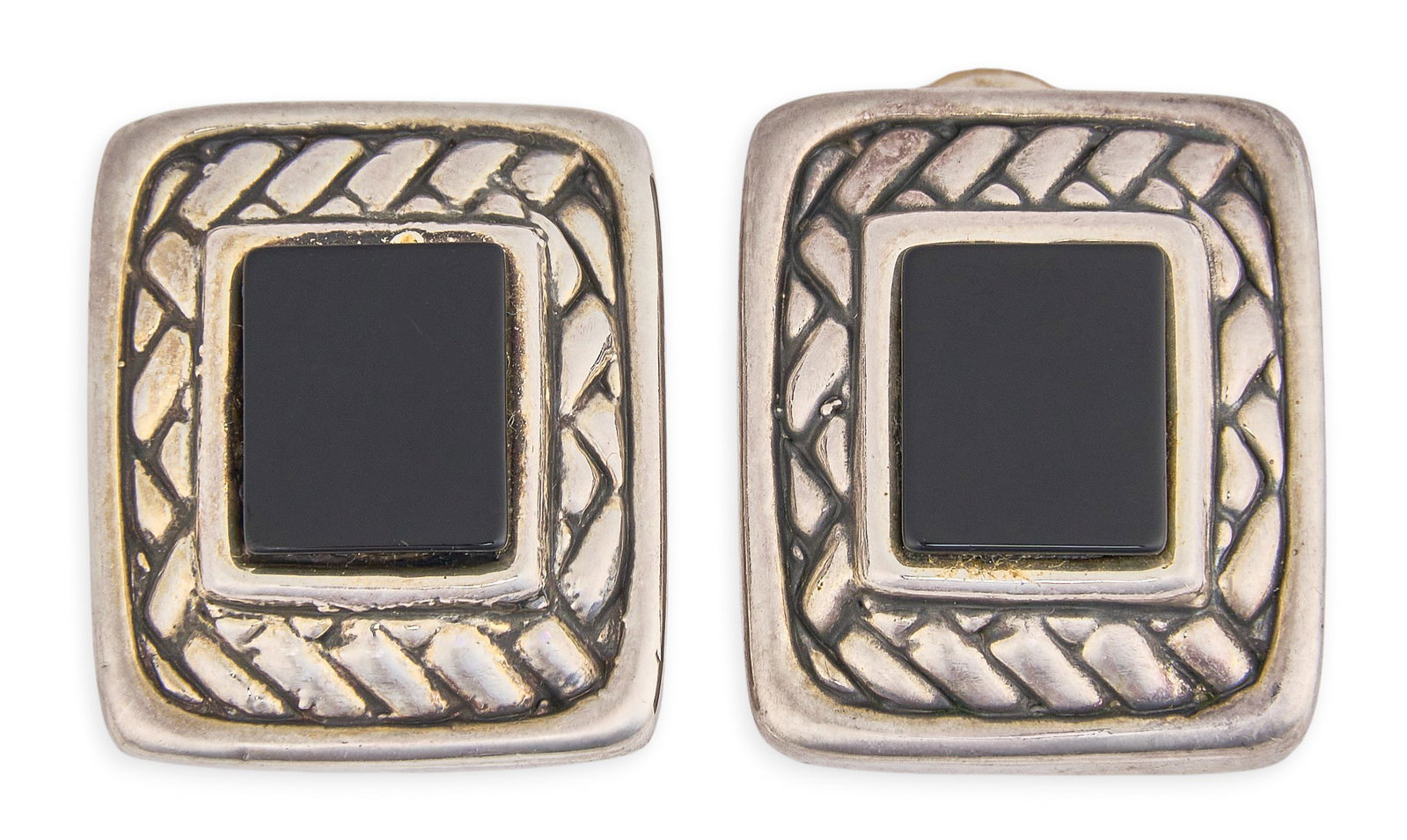 Red McCombs | Sterling Silver & Onyx Earrings: Pair of sterling silver clip-on earrings set with rectangular onyx cabochons and textured borders, marked "Sebbag 925" to reverse Size: 1 x 0.75 in. / each Total weight: 16.6 g Provenance: P