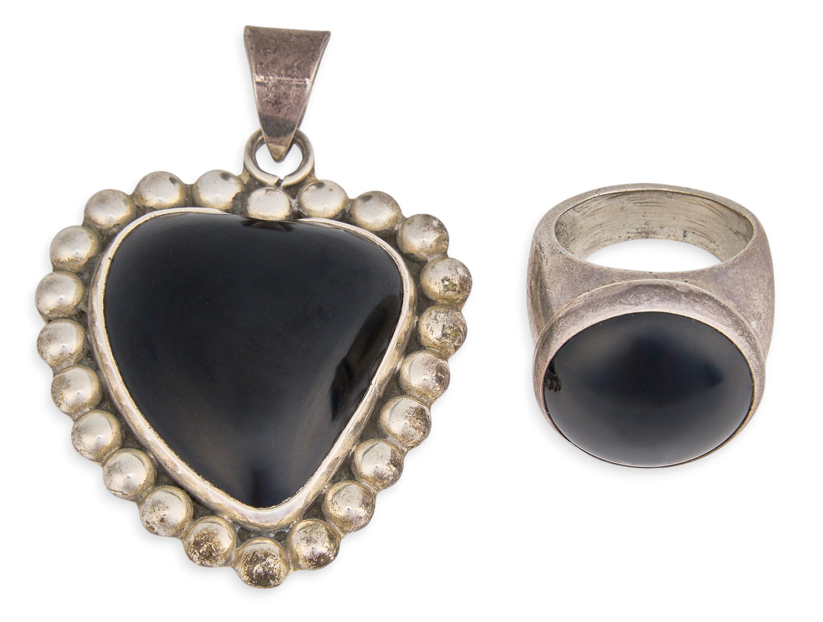 Red McCombs | Sterling Silver & Onyx Pendant and Ring: Sterling silver pendant and ring, each set with onyx cabochon, pendant featuring studded details to border, each hallmarked Size: 2.0 x 1.75 in. / pendant Size: 7 / ring Total weight: 42.3 g Provenanc