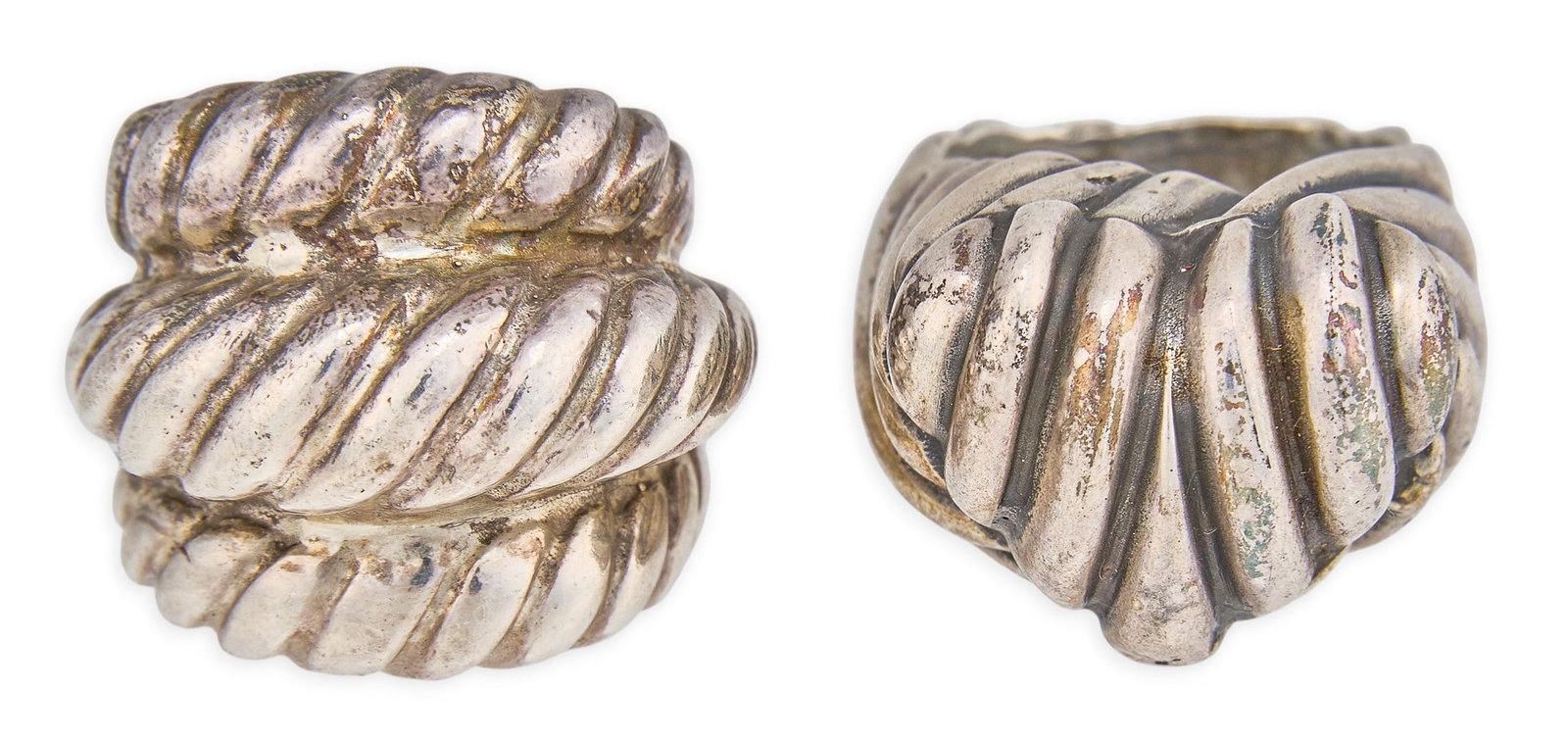 Red McCombs | (2) Sterling Silver Ribbed Rings: Two sterling silver rings, each with ribbed textured design, one featuring a central heart motif, marked "SS" Size: 6.75 / each Total weight: 38.3 g Provenance: Property from the personal es