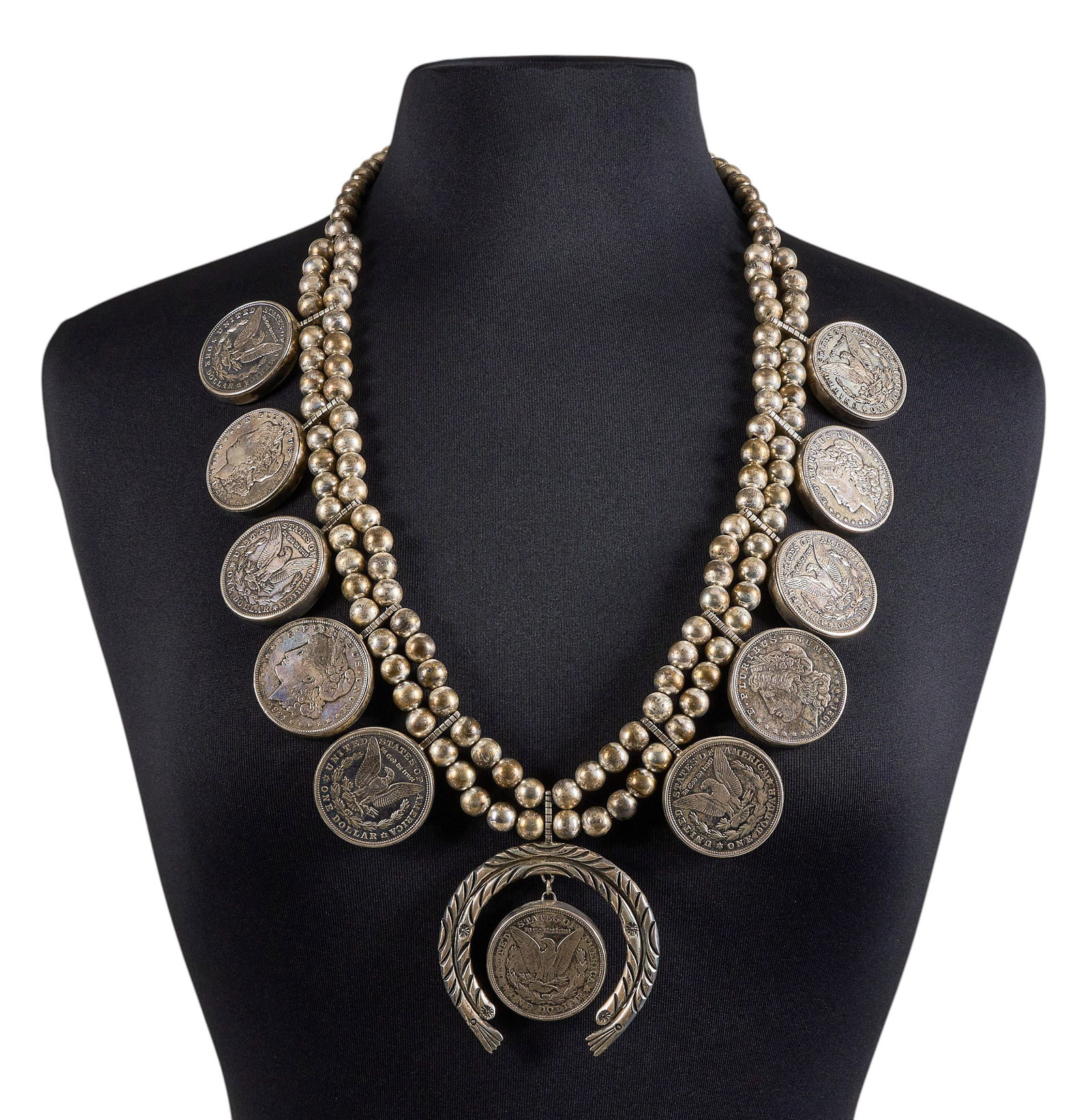 Red McCombs | Zuni Sterling Silver Dollar Necklace: Zuni sterling silver necklace composed of bezel-set silver dollars on two strands of sterling Navajo pearls, stamped "Sterling" with maker's mark to pendant's reverse, hook and 