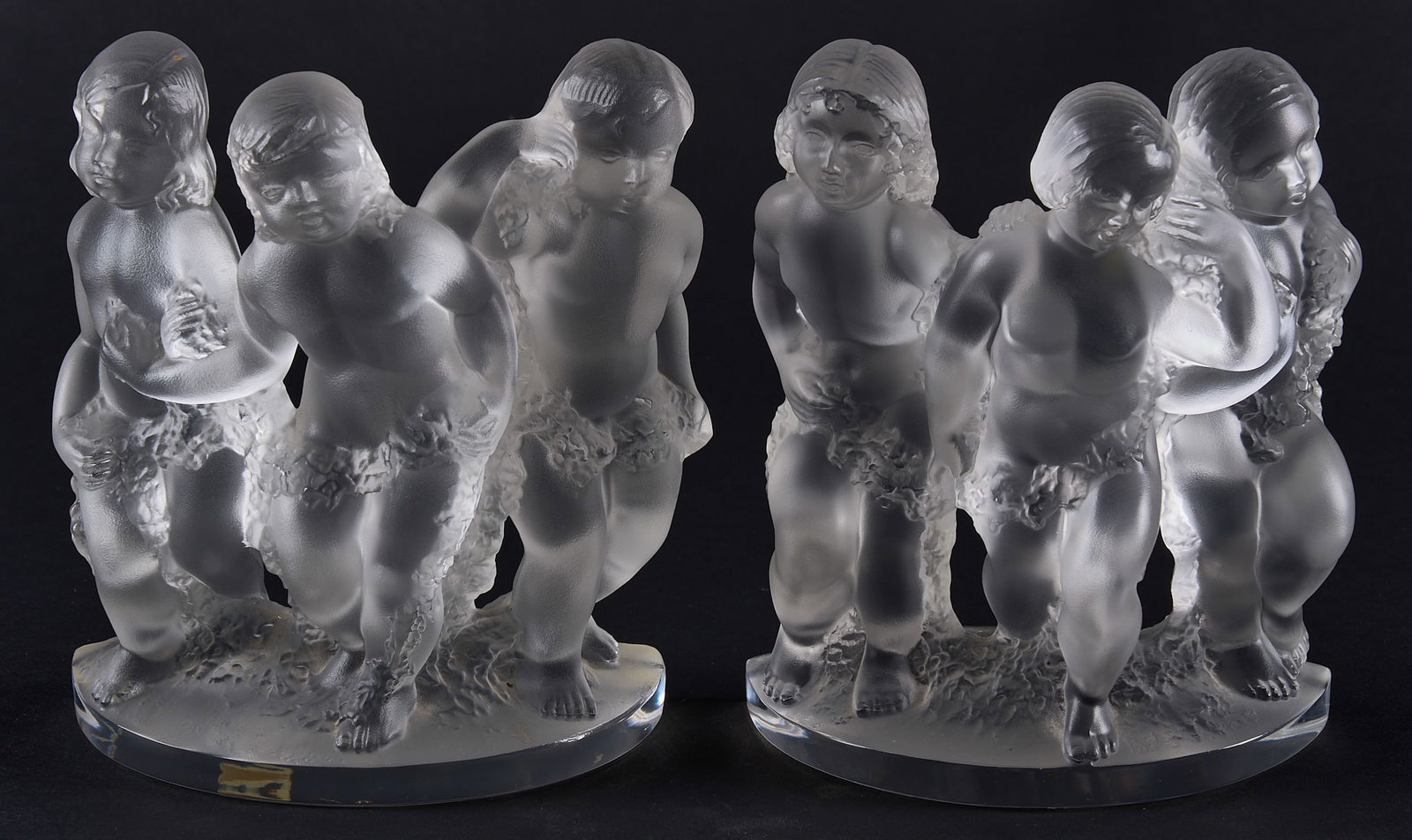 Red McCombs | Pair of Lalique "Luxembourg" Bookends: Pair of Lalique "Luxembourg" bookends, features frosted crystal putti with garlands, signed height 8 in. x width 6.5 in. x depth 3.5 in. / each Provenance: Property from the personal es