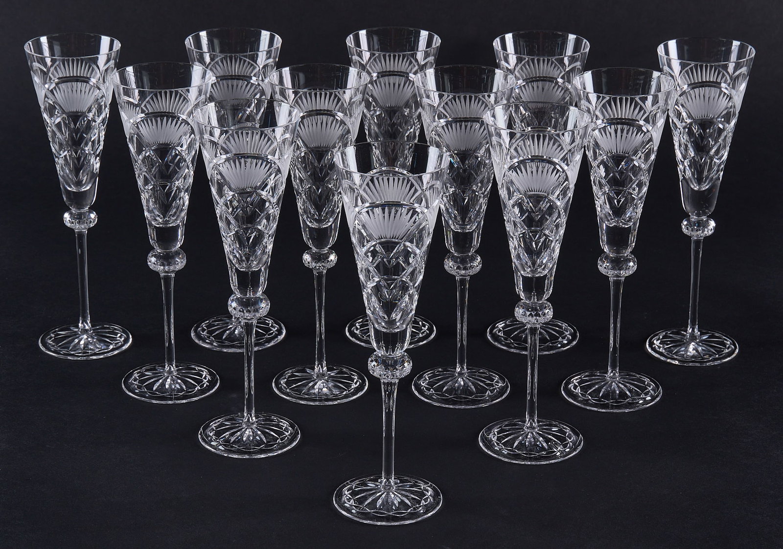 Red McCombs | (12) Cut Crystal Champagne Flutes: Set of twelve cut crystal champagne flutes height 9.75 in. Provenance: Property from the personal estate collection of iconic Texas businessman, civic leader and philanthropist Billy Joe R