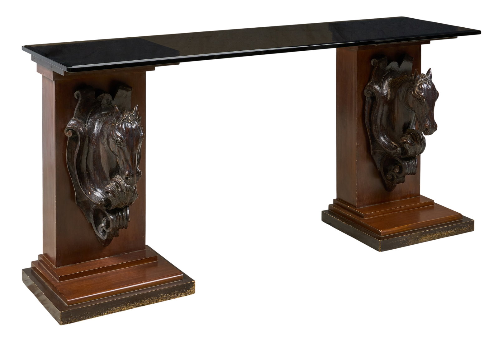 Red McCombs | Horsehead Pedestal Table: Dark glass top entry table supported on matched pair of pedestals, each with rectangular top, columnar standard mounted with patinated horse head, stepped rectangular plinth height 34.5 in. x width 72