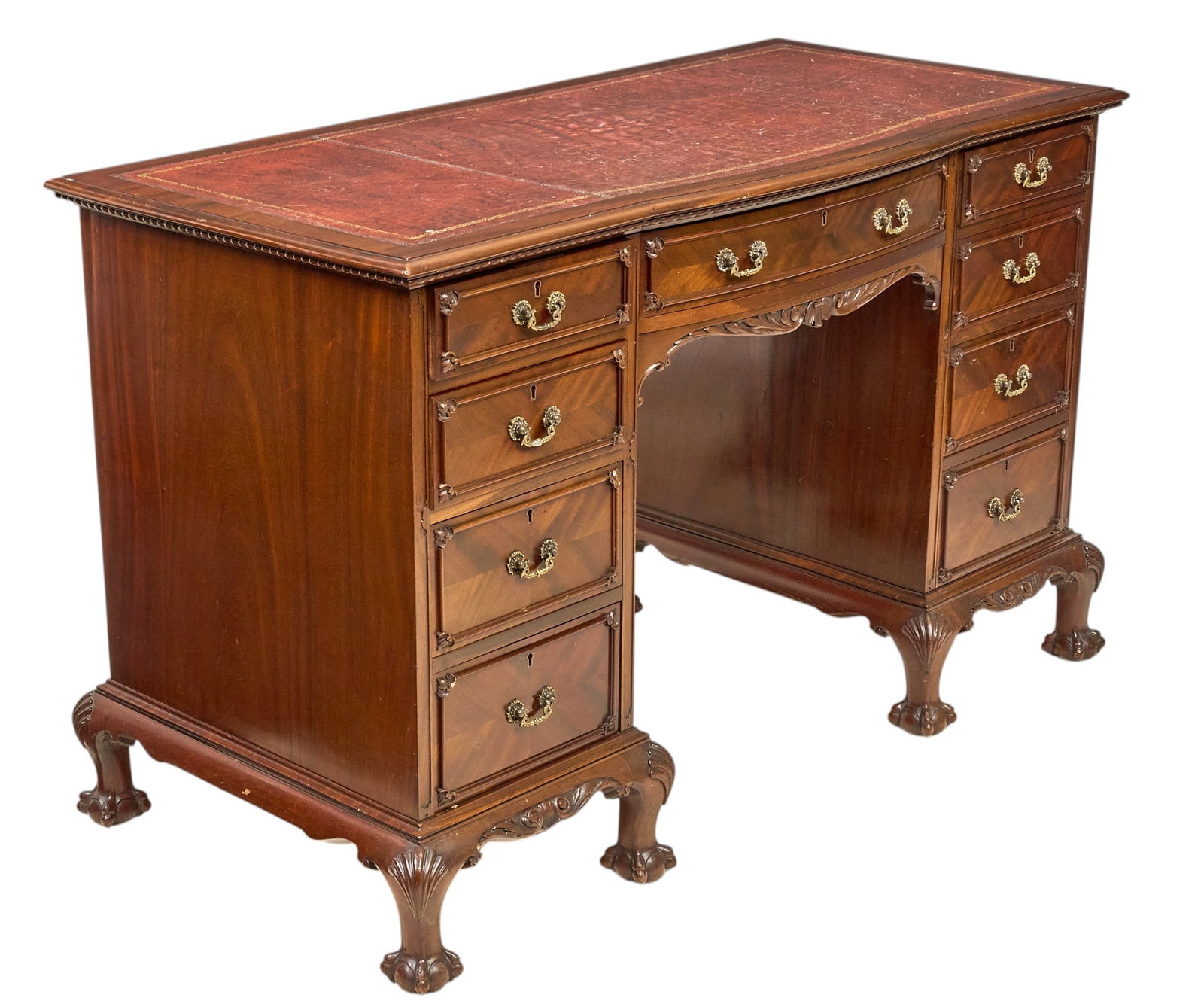Red McCombs | Chippendale Revival Pedestal Desk: English Chippendale Revival mahogany pedestal desk, rectangular top inset with gilt-tooled leather writing surface, nine drawers with brass pulls, carved foliate kneehole, cabriole legs with ball and 