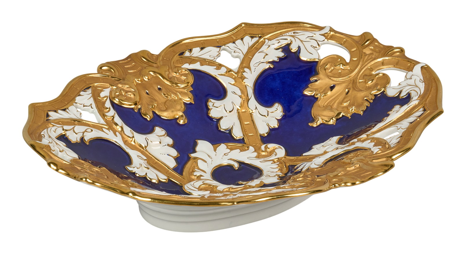 Red McCombs | Meissen Centerpiece: Meissen cobalt and gilt porcelain reticulated centerpiece, late 19th/early 20th century, elaborate Rococo Revival form with cobalt blue reserves, reticulated and molded foliate decoration heightened
