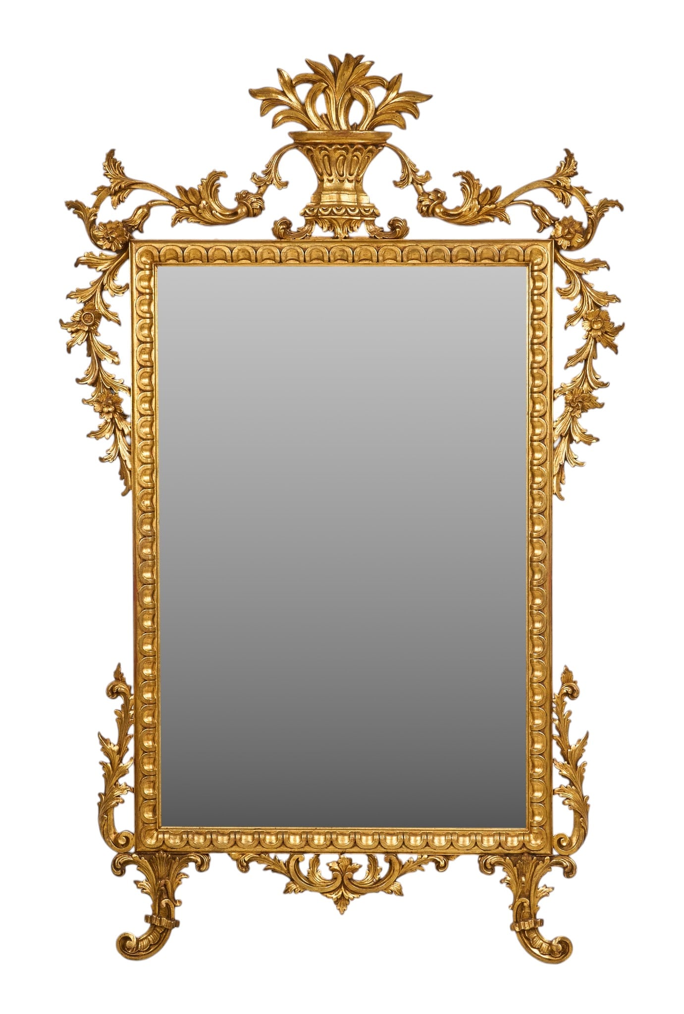 Red McCombs | Rococo Revival Giltwood Mirror: Rococo Revival giltwood mirror with urn finial, geometric pattern frame, adorned with leaf and floral carvings height 80.5 in. x width 50.5 in. x depth 2 in. Provenance: Property from the