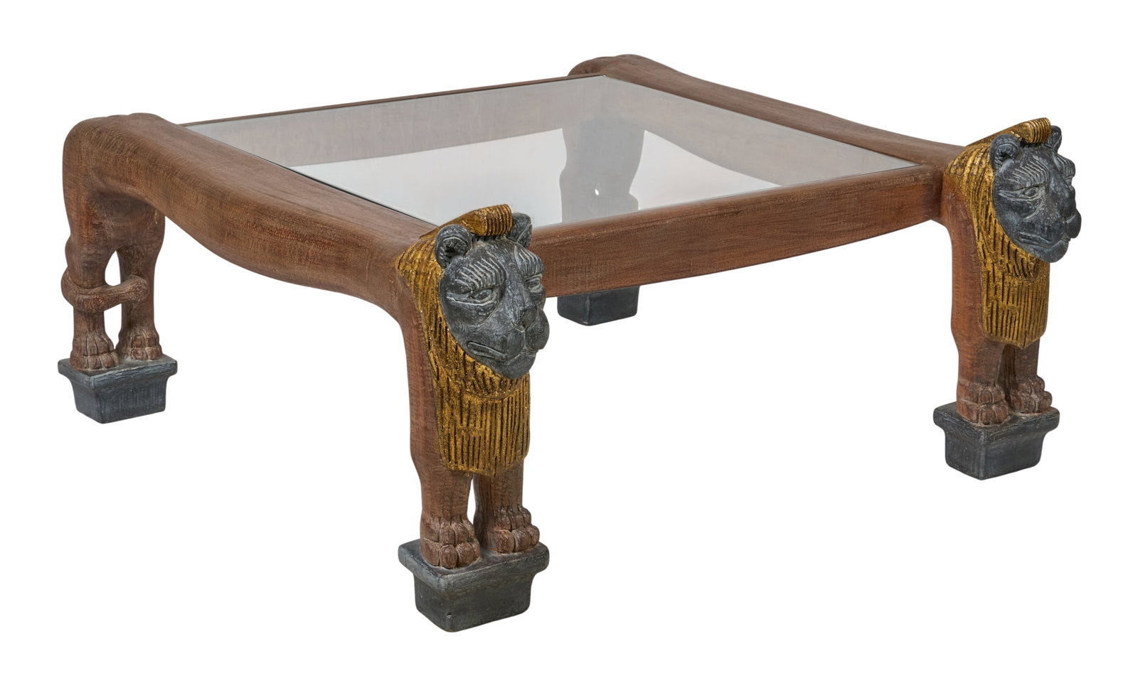 Red McCombs | Vintage Lion Coffee Table: Vintage carved and painted wooden coffee table with glass top and Egyptian Revival style design depicting standing lions, circa 1970s height 21 in. x width 42 in. x depth 42 in. Provenance: