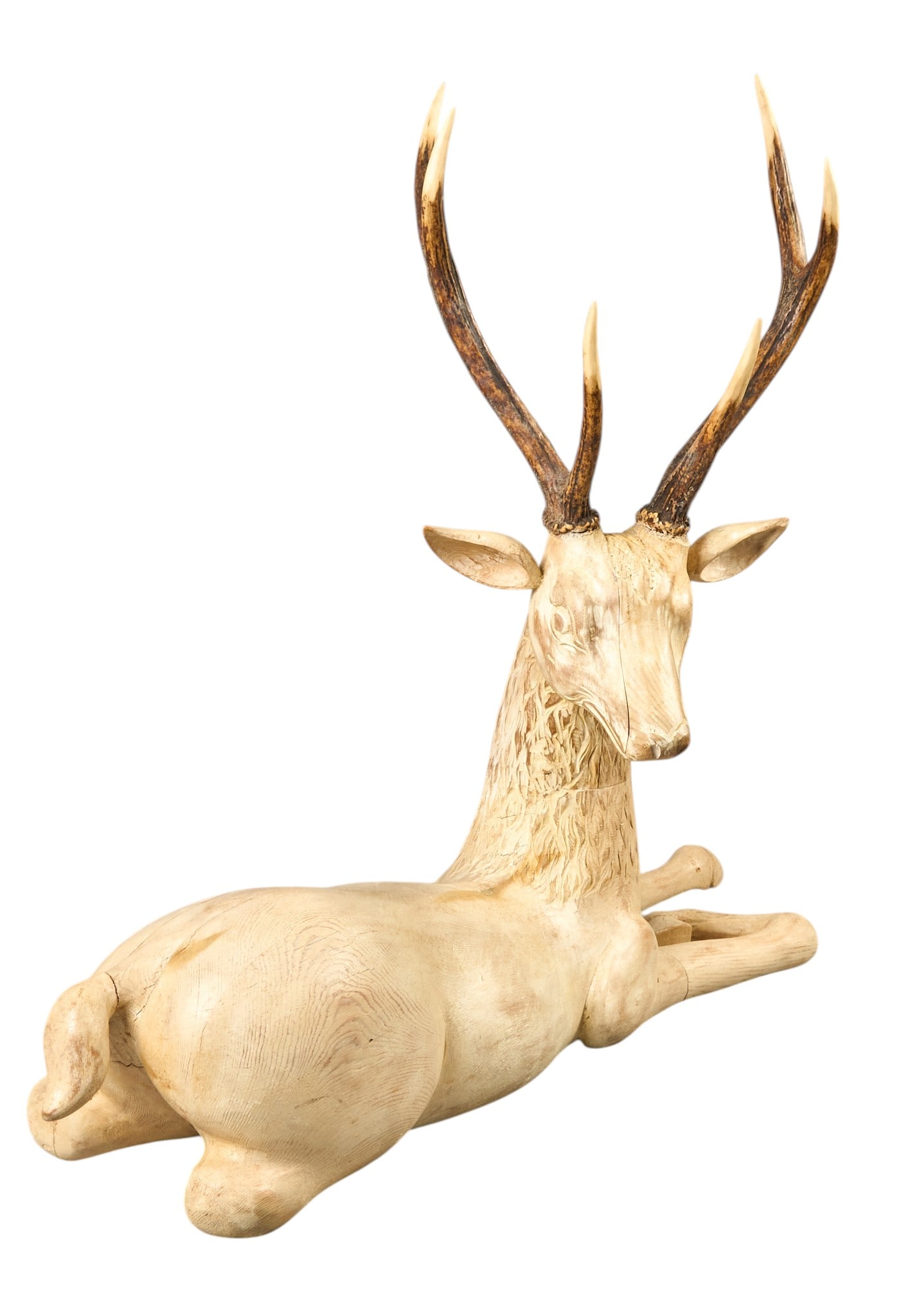 Red McCombs | Deer Folk Art Sculpture: Vintage hand-carved wooden folk art sculpture depicting reclining deer, with real antlers, signed "Csatay" height 29.5 in. x width 35 in. x depth 12 in. Provenance: Property from 