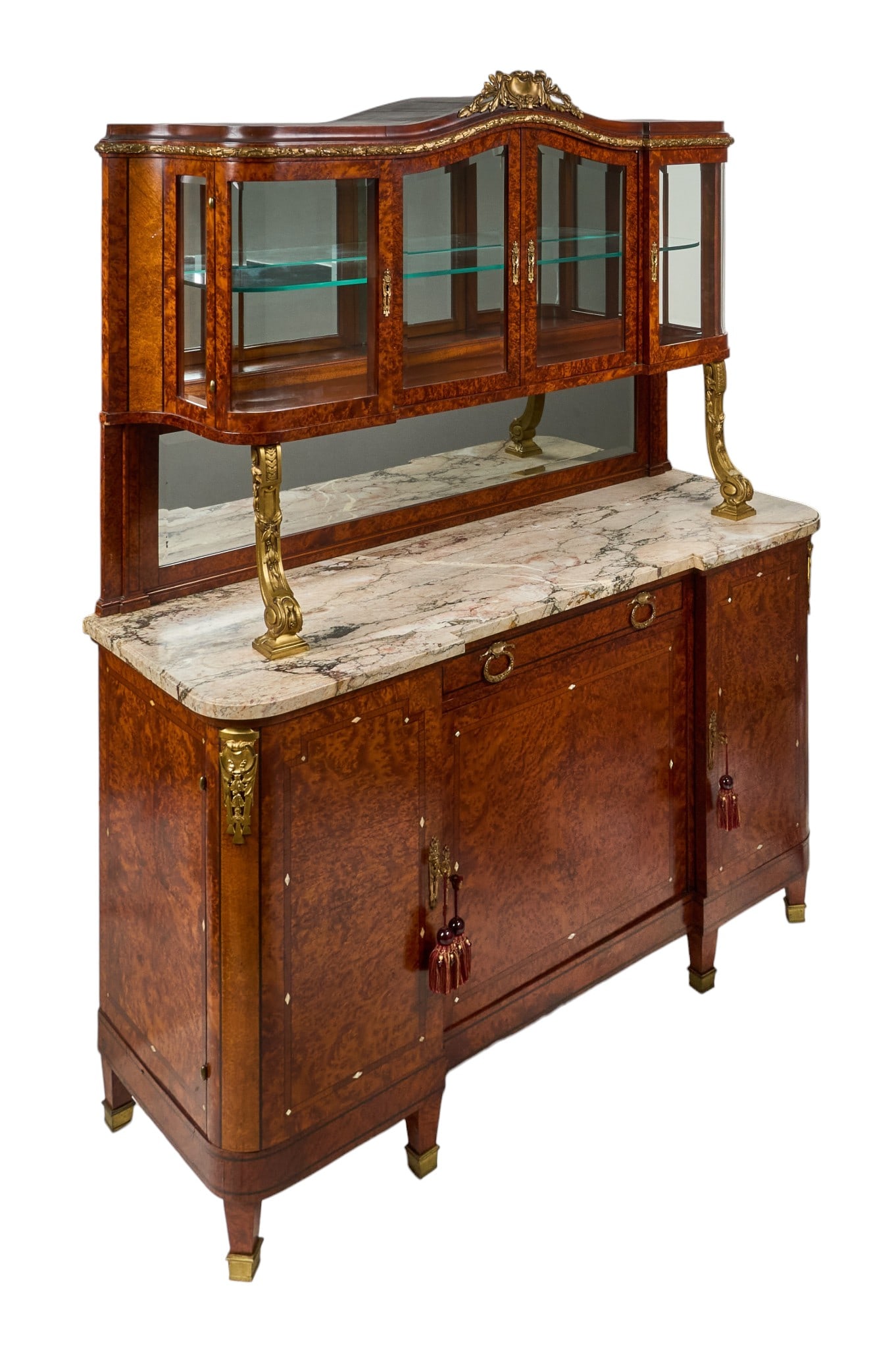 Red McCombs | French Louis XVI Style Buffet: Louis XVI style burlwood veneered buffet with upper glass-front cabinet with mirrored back and glass shelves, above mirrored gallery and veined marble counter, supported by scrolled gilt supports,