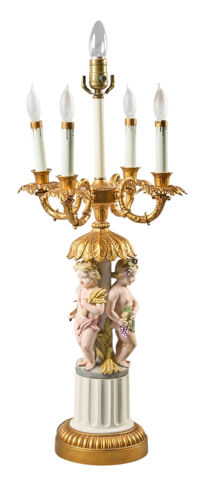 Red McCombs | Vintage Ceramic Putti Lamp: Vintage ceramic Rococo Revival style table lamp with five fixtures above three putti height 29.5 in. x width 13.5 in. x depth 13.5 in. Provenance: Property from the personal estate
