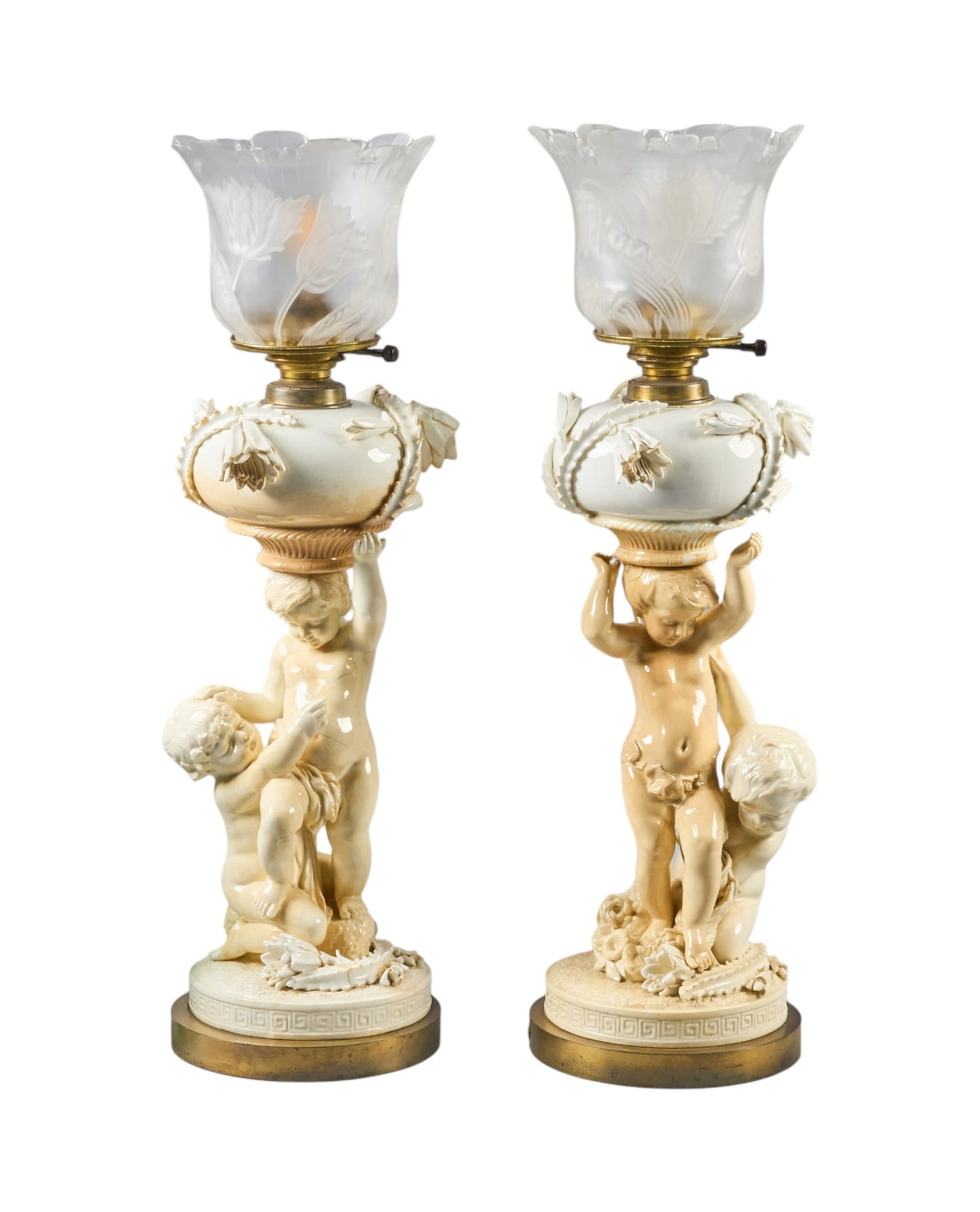 Red McCombs | Pair of Ceramic Putti Lamps: Pair of ceramic putti lamps, with sculpted putti supports, and frosted tulip shades height 27 in. x width 8 in. x depth 8 in. / each Provenance: Property from the personal estate colle