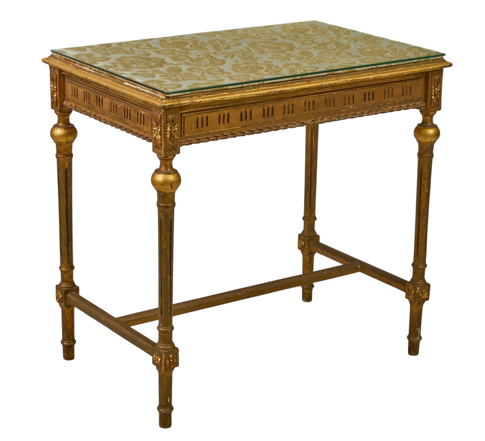 Red McCombs | Louis XVI Style Side Table: Louis XVI style side table with gilded wooden frame supported on turned legs with H-frame stretcher, and glass topper height 21.5 in. x width 33 in. x depth 21.5 in. Provenance: Property f
