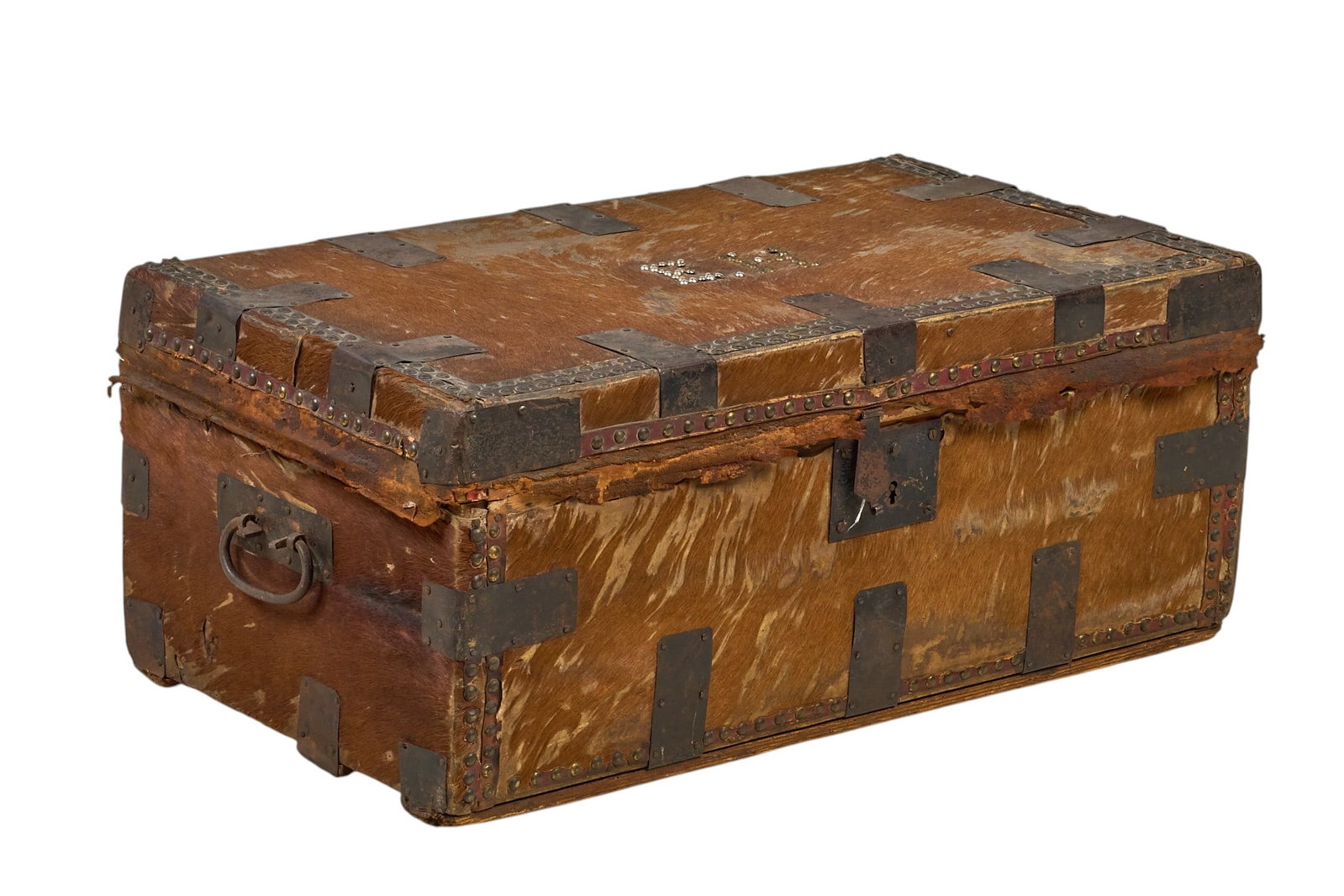 Red McCombs | Antique Coffer: Antique wooden coffer lined with hair-on cowhide, fortified with brass banding, with iron handles, decorated with E.H. initials on top, circa late 19th century height 12 in. x width 29 in. x