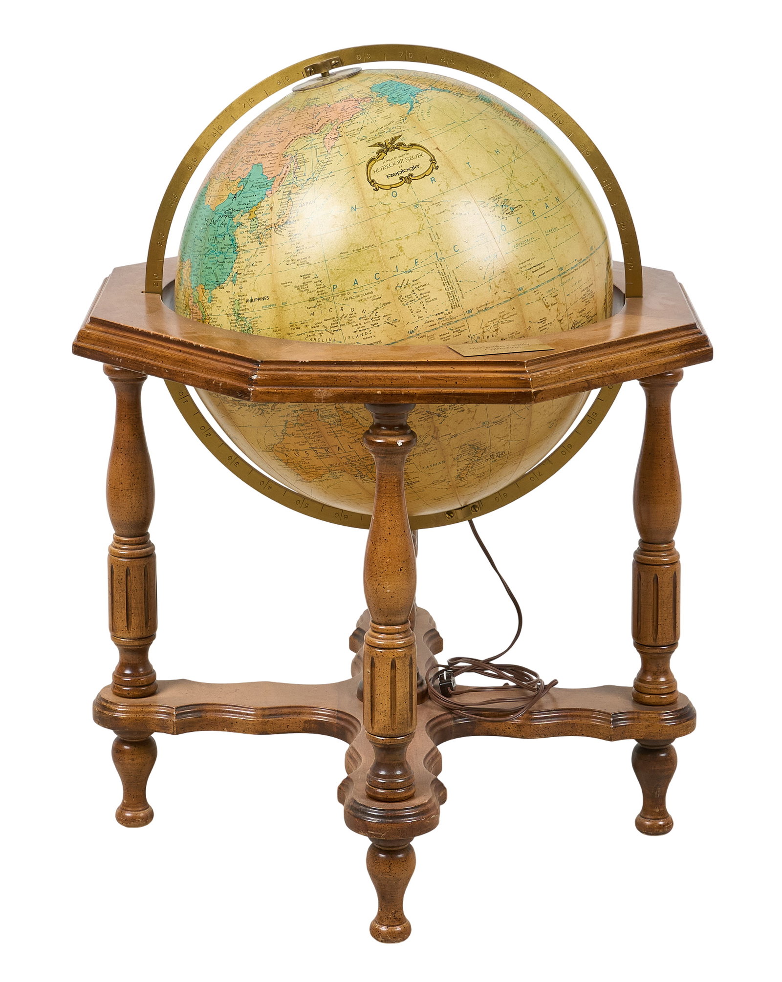 Red McCombs | Vintage Terrestrial Globe: Vintage lighted terrestrial globe supported in turned wooden frame, featuring "McCombs Family Collection" metal plaque; tested, does not currently light up height 35.5 in. x width 28 in. x d