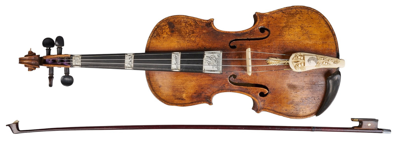 Red McCombs | Antique Scrimshaw Violin: 19th century violin decorated in scrimshaw ivory depicting whaling scenes, with two horse heads to tighten strings and the finger board has scenes mounted to its surface, with original case and b