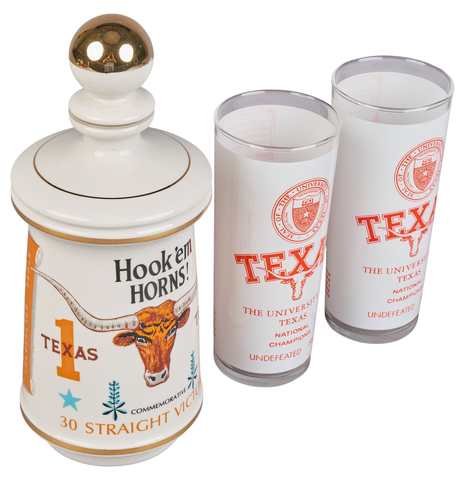 University of Texas Championship Decanter and Glasses Set: UT commemorative decanter and (2) championship glasses, decanter commemorating thirty straight victories, glasses featuring the UT logo and "Texas National Champions Undefeated 1969" height