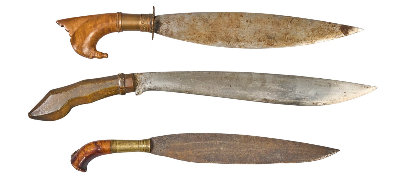 (3) Filipino Daggers: Three Filipino daggers with stylized wooden handles, and sheaths, with oxidized blades length 20.5 in. x width 2.25 in. / largest Provenance: Property from a home in San Antonio, Texas