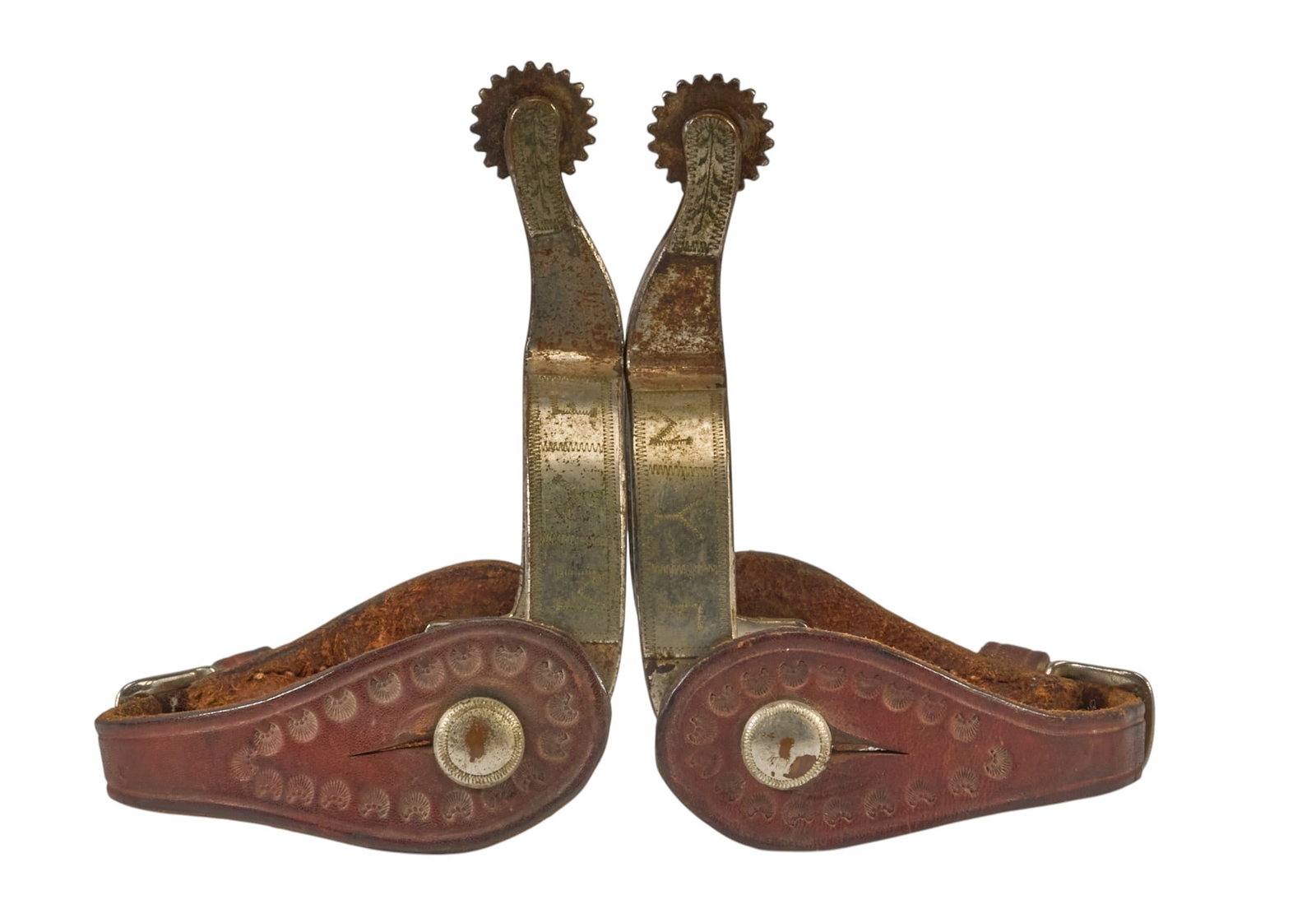 Pair of Rare Kelly Marked Spurs: Pair of rare "Kelly" marked spurs, with "WYF" and floral motif engravings on heel band overall length: 6 in. heel width: 3.5 in. rowel diameter: 1 in. 