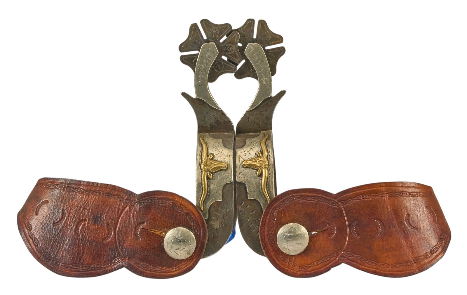 Pair of Don Pierce Texas Longhorn Spurs: Don Pierce Texas longhorn pattern spurs, with cloverleaf rowels, silver overlay, and leather heel strap, maker marked overall length: 6.5 in heel width: 3 in. rowel diameter: 2 in. 