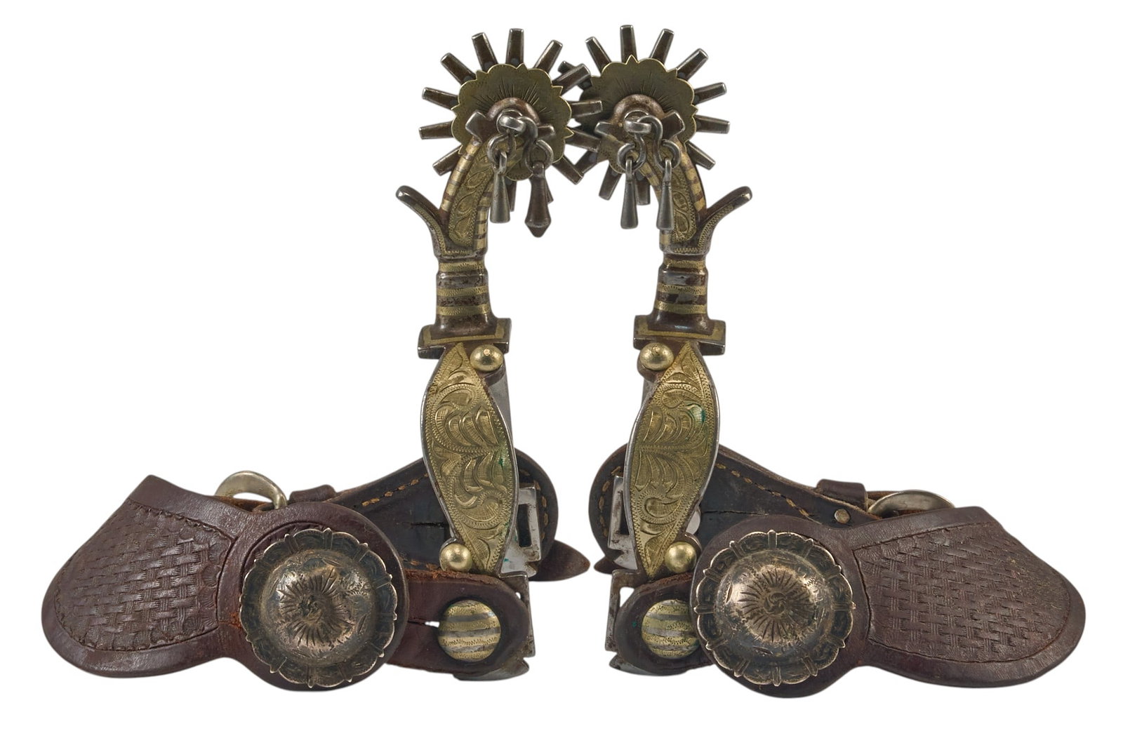 Pair of GJ Marked California Style Spurs: GJ marked California style spurs with silver inlay, and tooled leather heel strap overall length: 7 in. heel width: 3.25 in. rowel diameter: 2 in. Provenance: Property from a