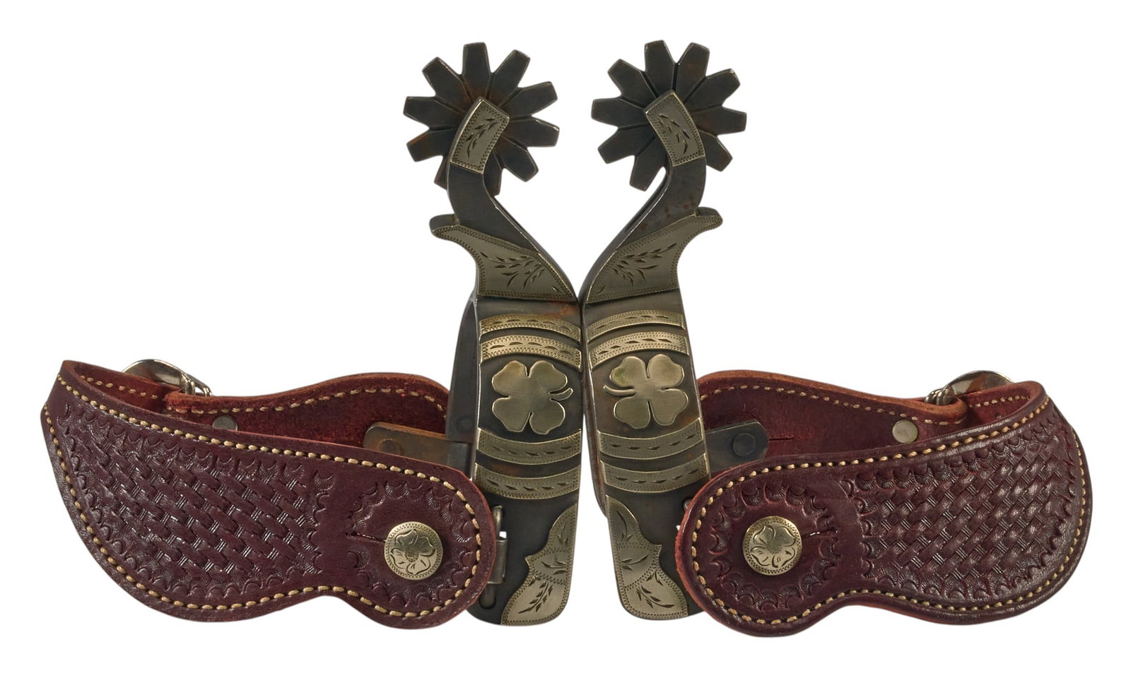 Pair of Card Suite Shamrock Maker Made Spurs: Pair of card suite shamrock maker made spurs, with silver mounts, and tooled leather heel strap overall length: 7 in. heel width: 3.5 in. rowel diameter: 2 in. 