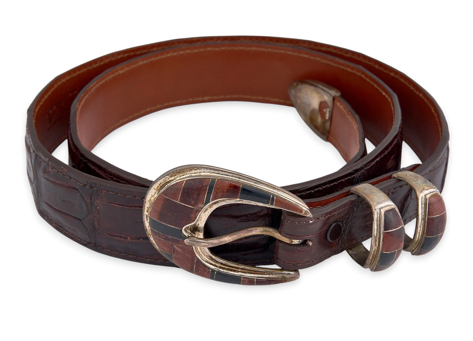 James Reid Crocodile and Sterling Belt: James Reid genuine caiman crocodile leather belt with inlaid sterling silver buckle Length: 45.5 in. Total weight: 202.1 g Provenance: Property from a home in Boerne, Texas