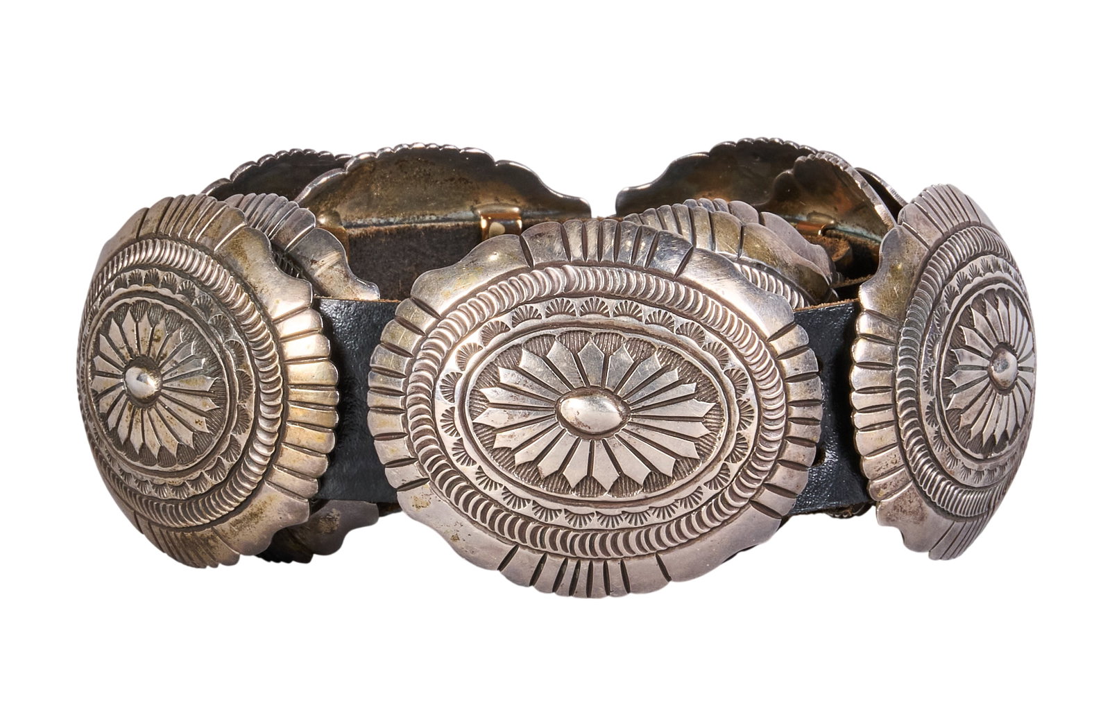 Navajo Sterling Silver Concho Belt: Navajo sterling silver concho belt featuring nine conchos and buckle on black leather belt, buckle signed "L Martinez" Length: 37 in. Total weight: 569.3 g Provenance: Property from a