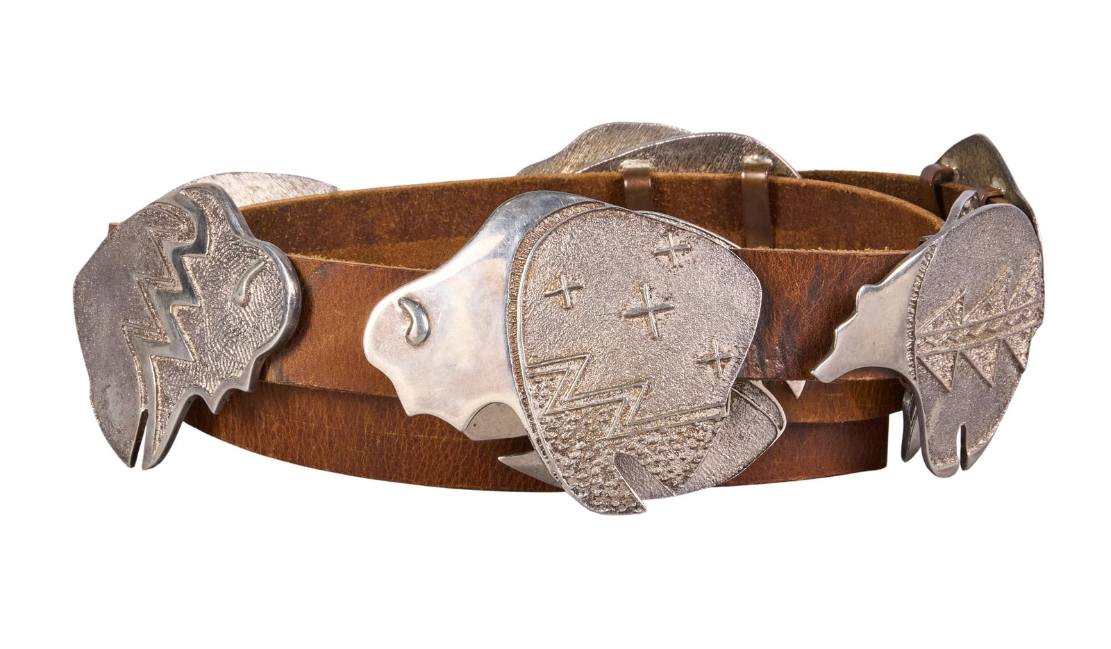 Hopi Tufa Sterling Animal Motif Concho Belt: Hopi tufa-cast sterling silver concho belt featuring eight animal motif conchos and buckle on brown leather belt Length: 48.75 in. Total weight: 903.1 g Provenance: Property from a home in San