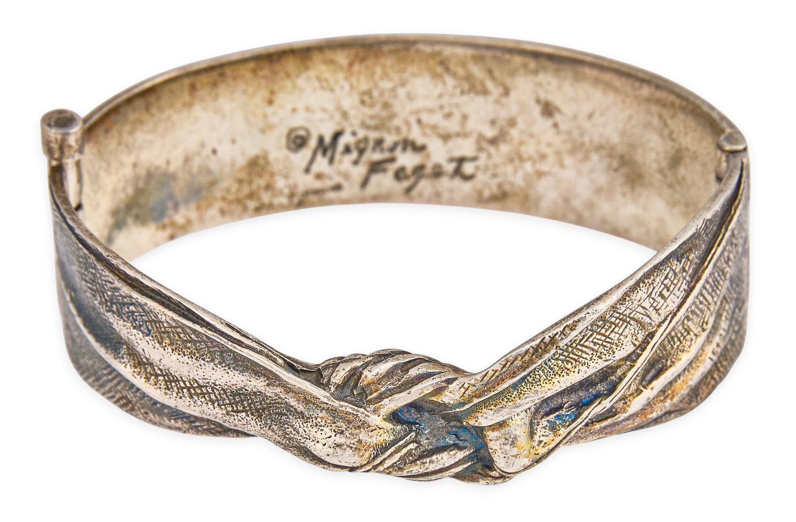 Mignon Faget Sterling Silver Cuff: Sterling silver hinged cuff with knot design, marked "Mignon Faget Sterling" Circumference: 6.5 in. Total weight: 1.59 ozt Provenance: Property from a home in San Antonio, Texas
