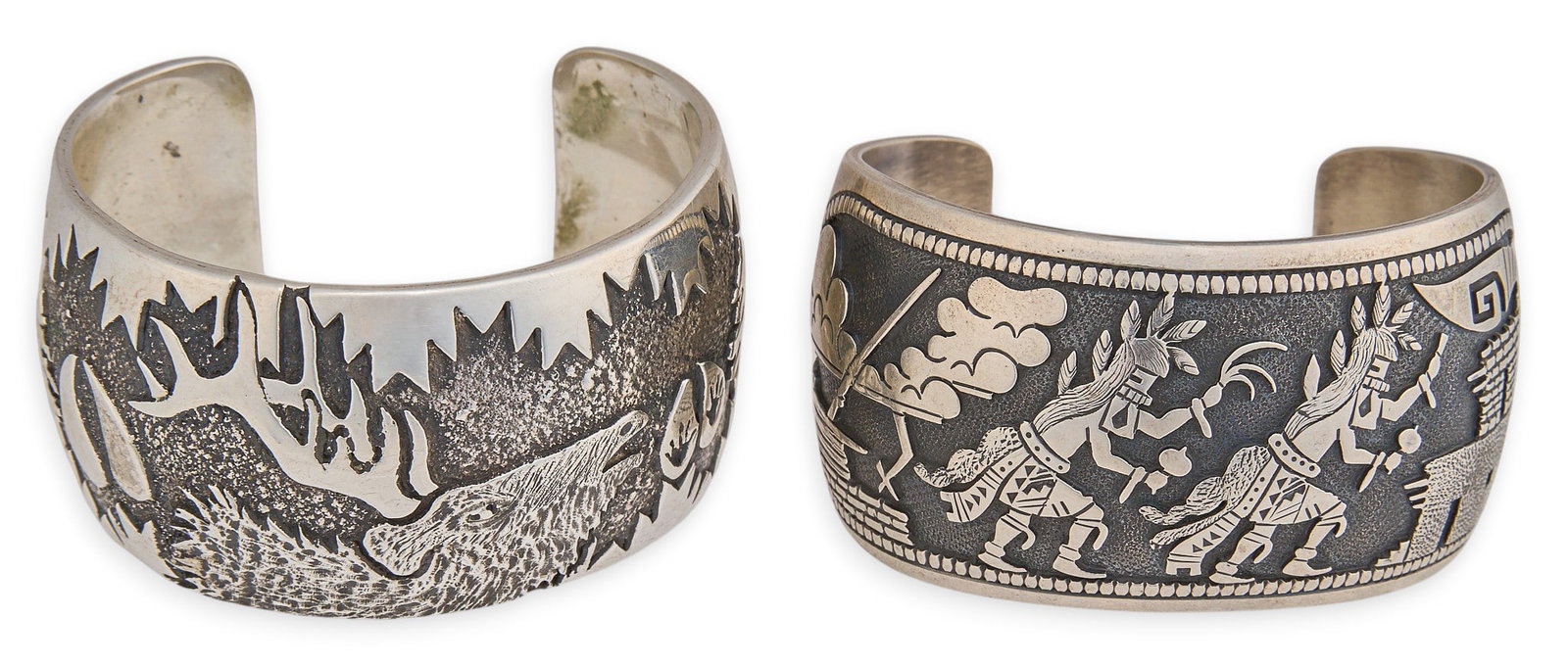 (2) Southwestern Sterling Overlay Cuffs: Two Southwestern sterling silver cuff bracelets, each featuring silver overlay depicting figural scenes of Hopi dancers and an elk head, marked Circumference: 6.75 in. / largest Total weight: 176.9 g 