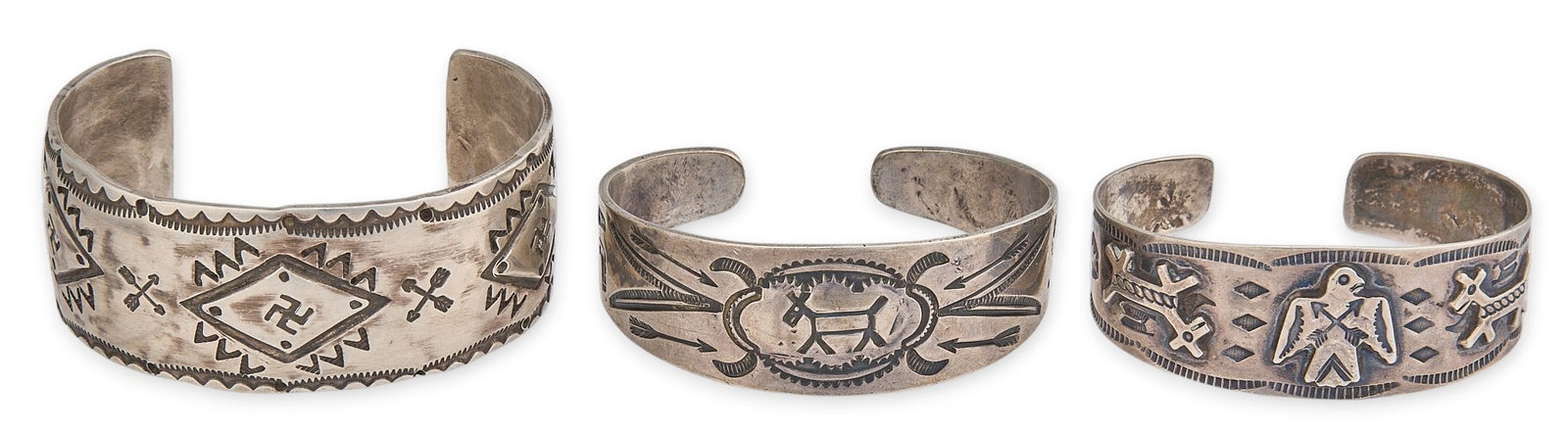 (3) Harvey Era Sterling Silver Cuffs: Three Harvey era sterling silver cuff bracelets, depicting various traditional motifs and stamped details throughout Circumference: 7.25 in. / largest Total weight: 120.5 g Provenance: Property from a