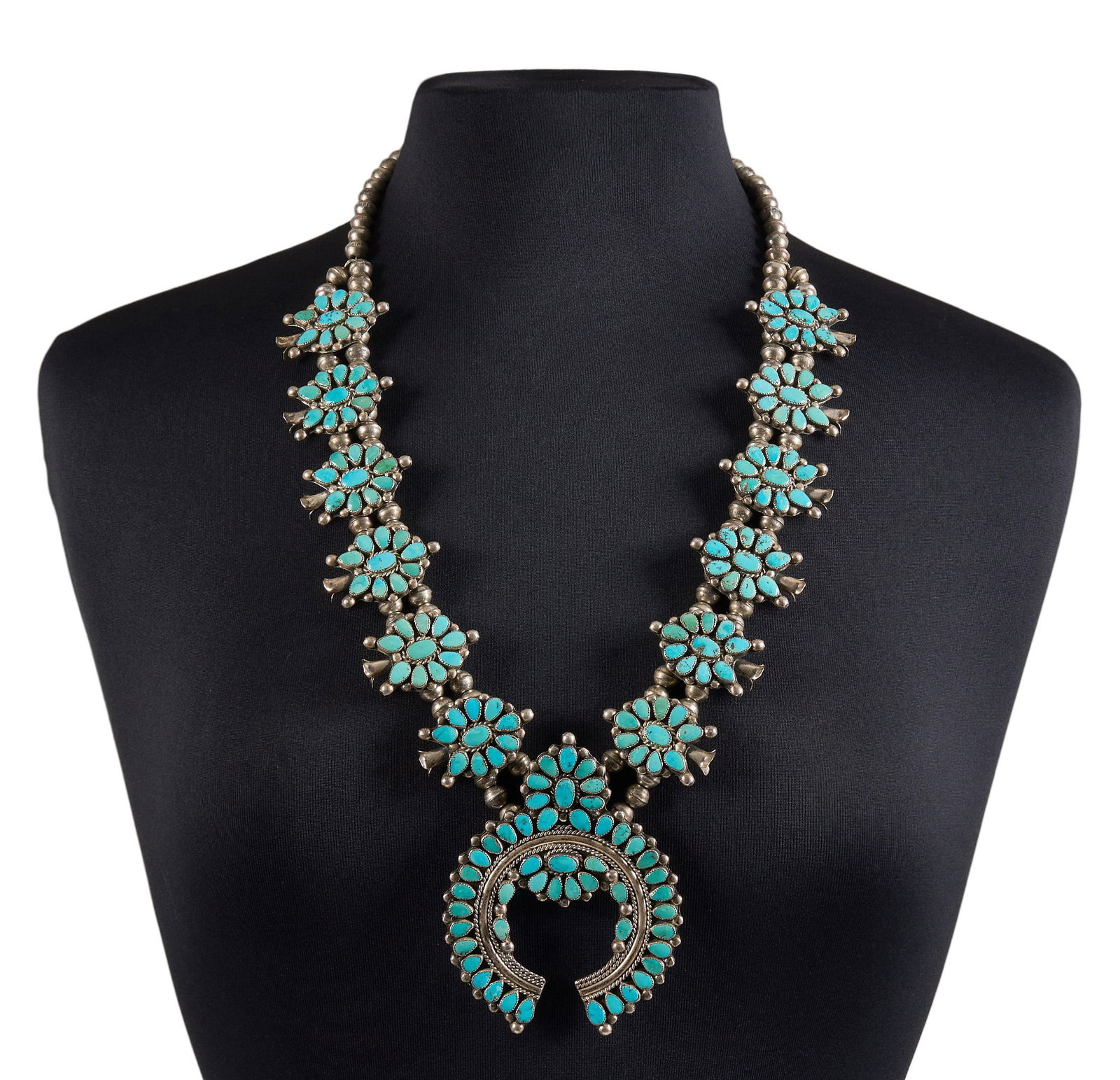 Turquoise Cluster Squash Blossom: Paul & Nancy Leekity, Zuni sterling silver squash blossom necklace set with turquoise cabochons in cluster design, with hook and eye closure, marked "PLN" Length: 30 in. Total 