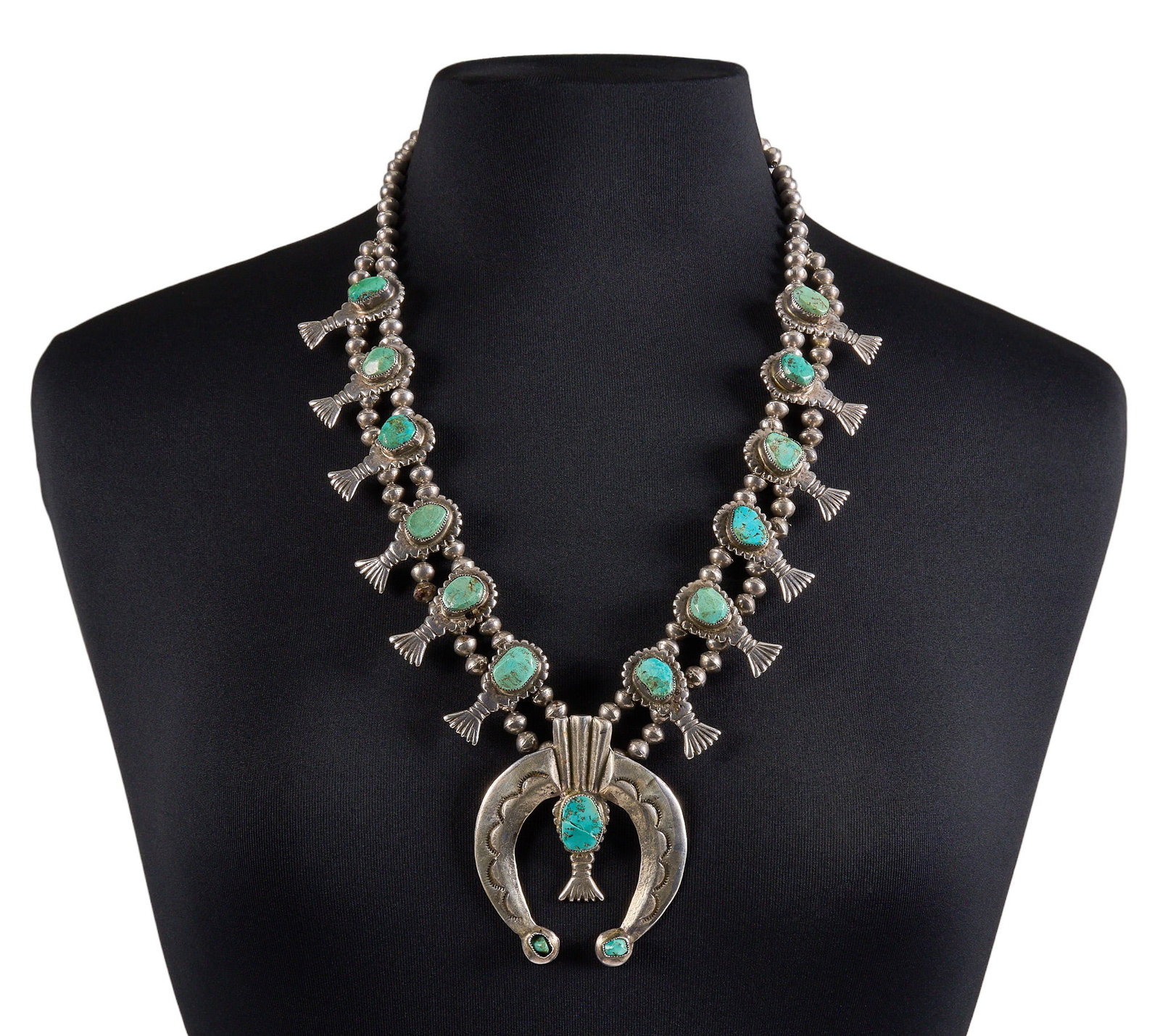 Vintage Navajo Sterling & Turquoise Squash Blossom: Vintage Navajo sterling silver squash blossom necklace, set with turquoise cabochons and substantial naja pendant, with hand-stamped details and hook and eye closure Length: 25 in. Total weight: 