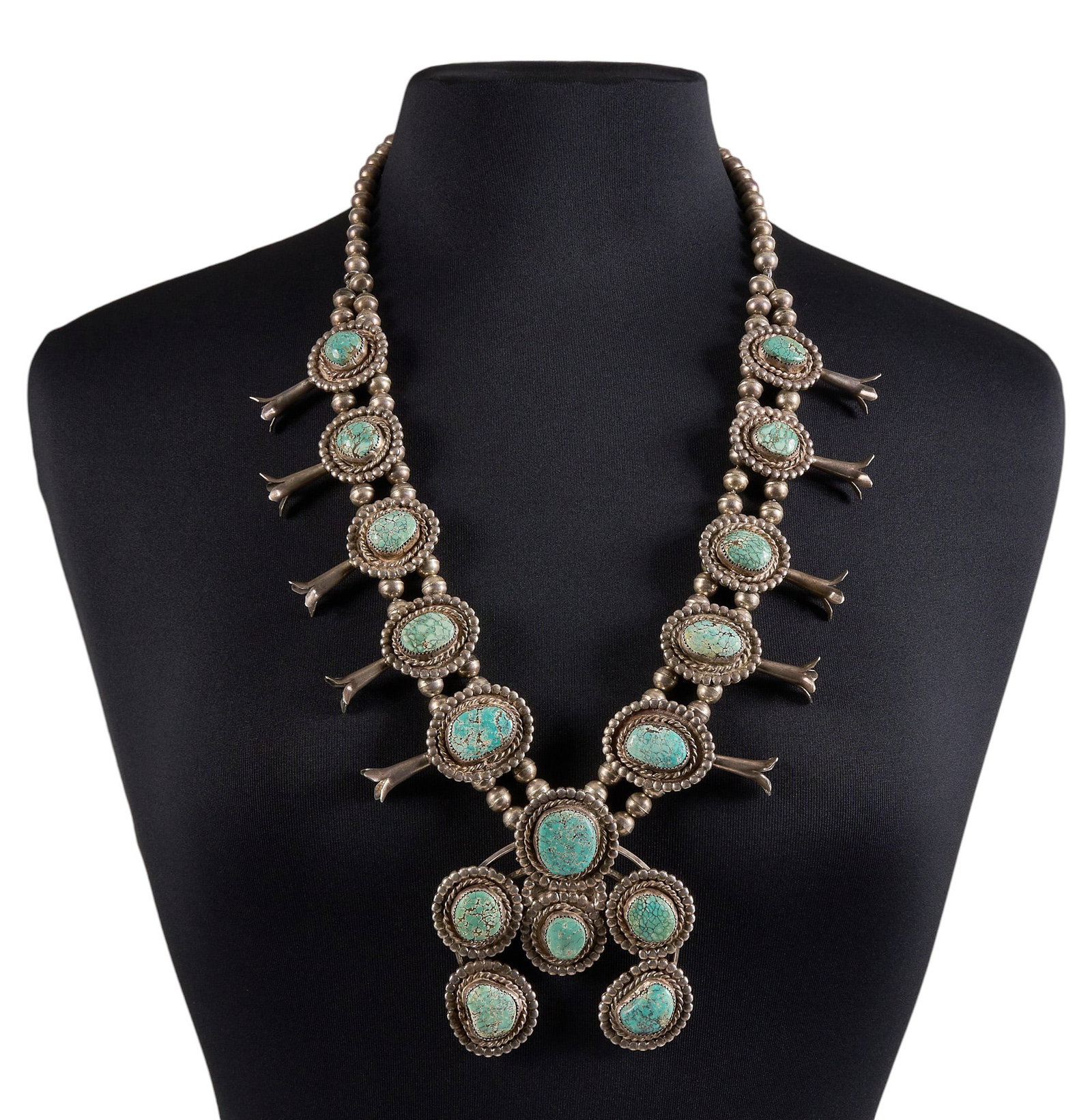 Vintage Sterling Silver & Turquoise Squash Blossom: Vintage sterling silver squash blossom necklace set with turquoise cabochons in twisted wire style settings, signed "CH" to naja, circa 1970s Length: 31 in. Total weight: 326.1 g Proven