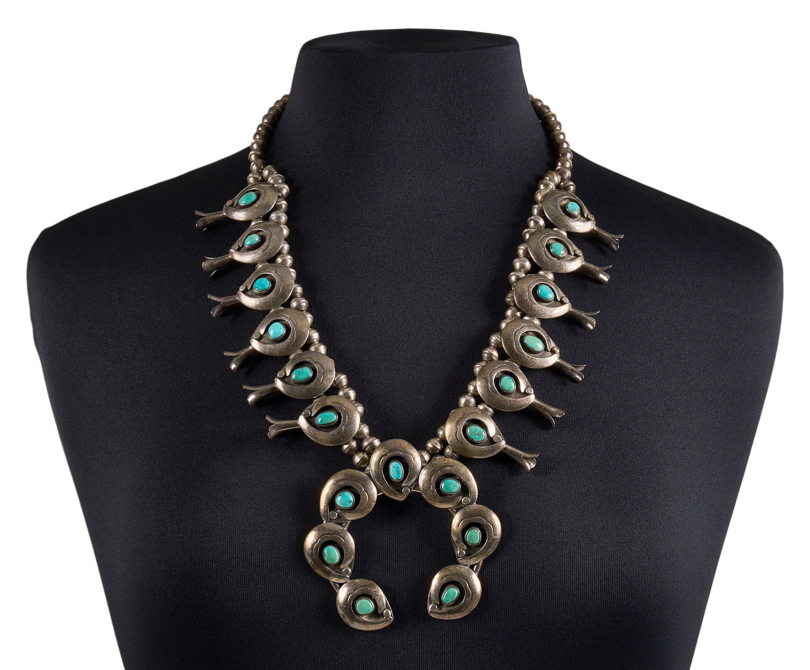 Southwestern Sterling & Turquoise Squash Blossom: Southwestern sterling silver squash blossom necklace, set with turquoise cabochons in shadowbox style settings, with hook and eye closure, marked "FS" to naja Length: 26 in. Total weight: 16