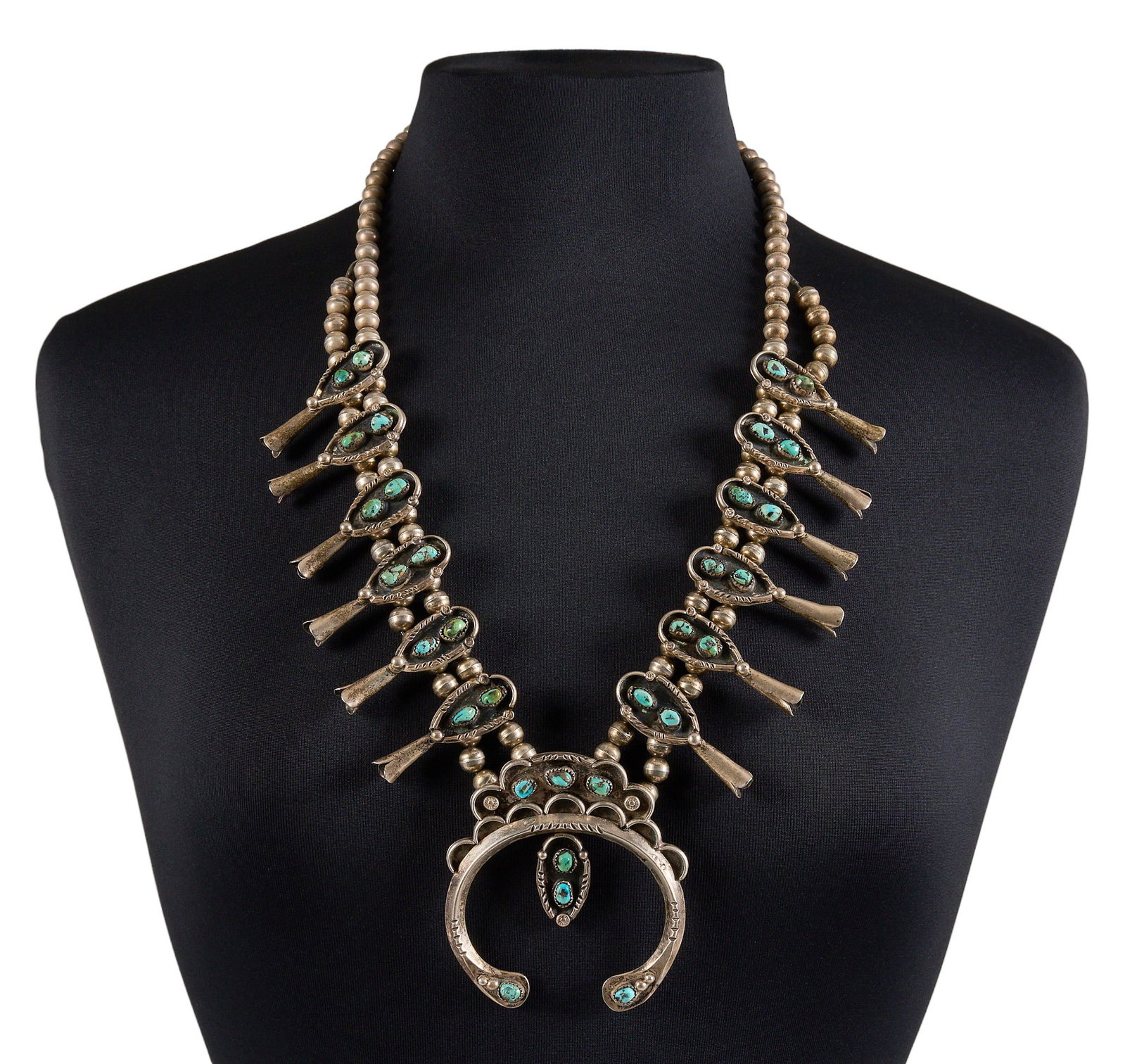 Vintage Navajo Sterling & Turquoise Squash Blossom: Vintage Navajo sterling silver squash blossom necklace, set with turquoise cabochons and large naja pendant, stamped details throughout, and hook and eye closure Length: 28 in. Total weight:
