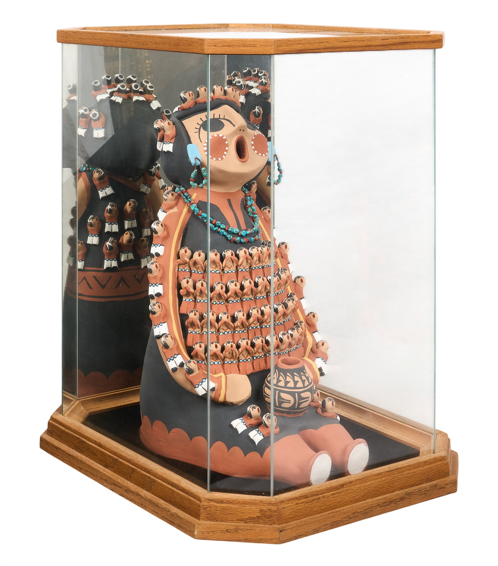 Storyteller Doll in Display Case: Hand-modeled and painted Southwestern ceramic storyteller doll, housed in custom mirrored display case height 22.5 in. x width 16 in. x depth 20.5 in. / with case Provenance: Property from the pe