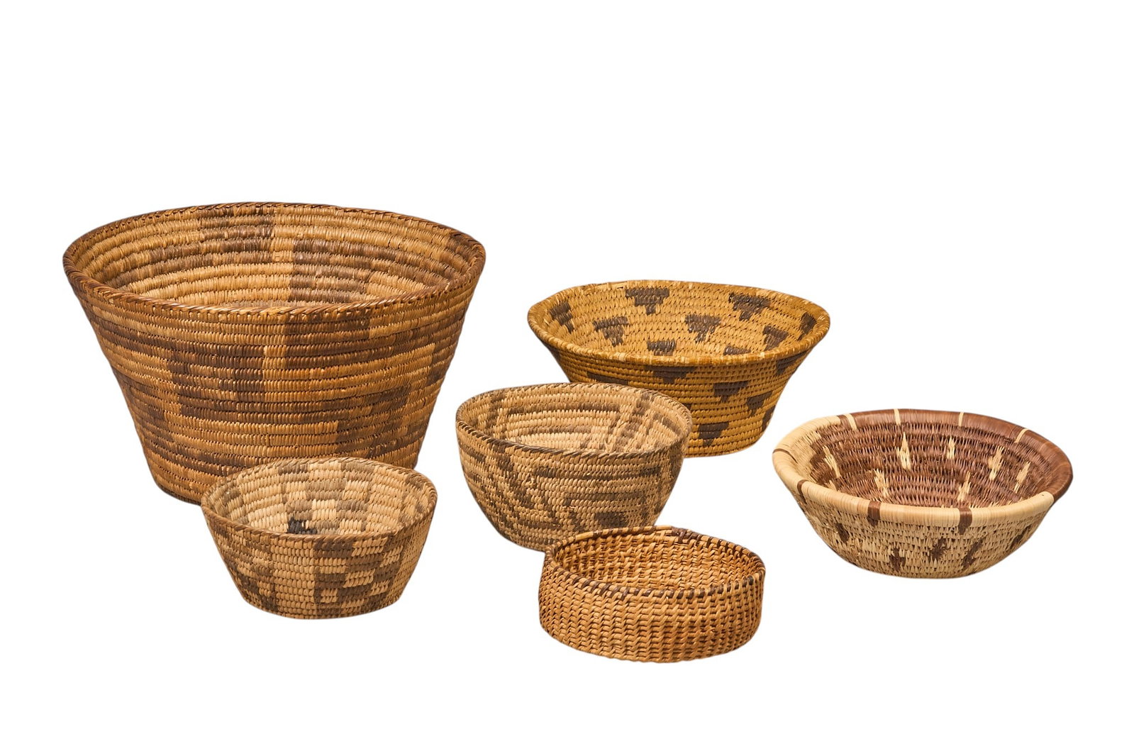 Collection of (6) Handwoven Native American Baskets: Collection of six handwoven Native American baskets, of various sizes and geometric designs height 6 in. x diameter 10.5 in. / largest Provenance: Property from a home in San Antonio, Texa