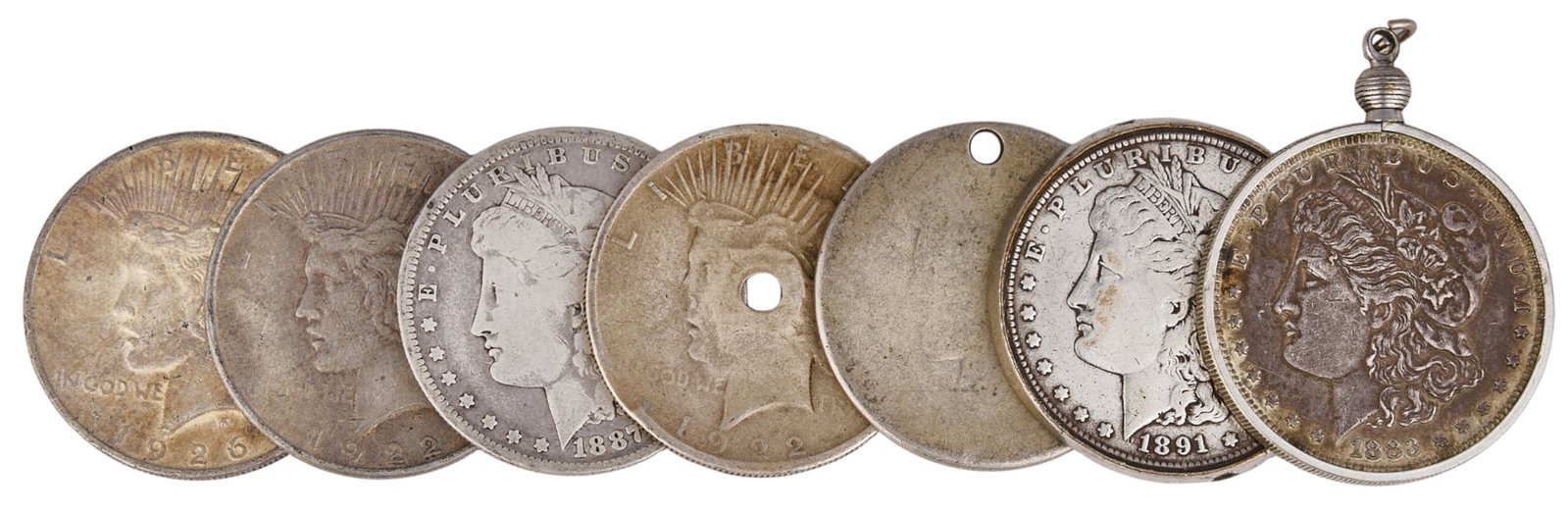 (7) Silver Dollars: Seven assorted silver dollar coins Provenance: Property from the Estate of Joy Speck Wilson (1942-2026) from her Menard, Texas ranch home