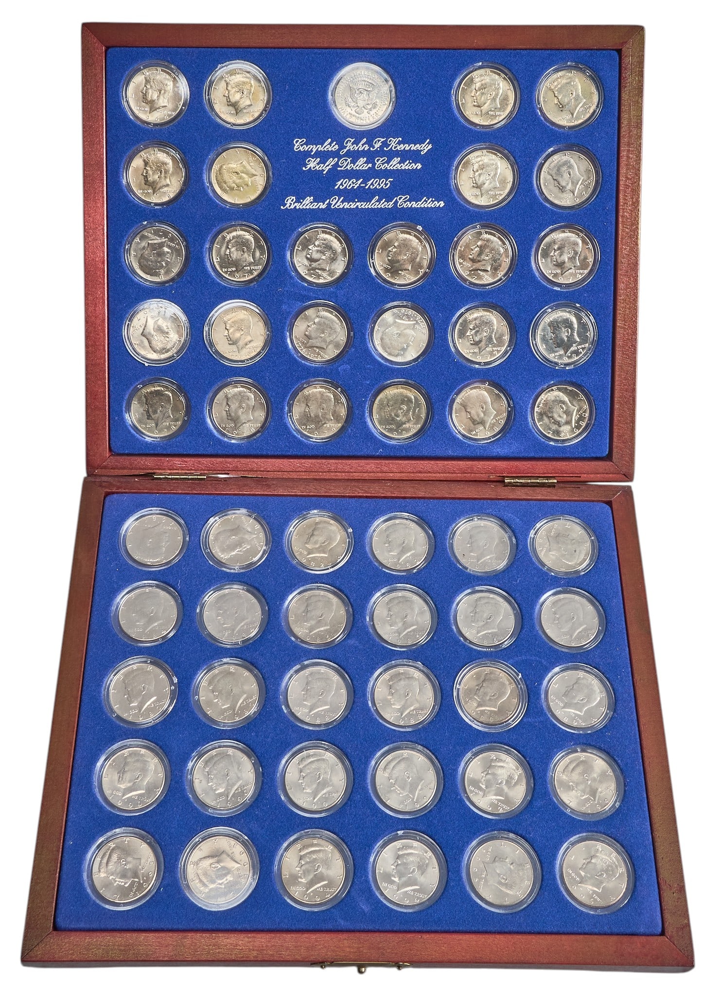 Collection of John F. Kennedy Half Dollar Coins: Collection of John F. Kennedy half dollar coins, with wooden display case with a blue velvet lining Provenance: Property from the Estate of Joy Speck Wilson (1942-2026) from her Menard, Texas ranch
