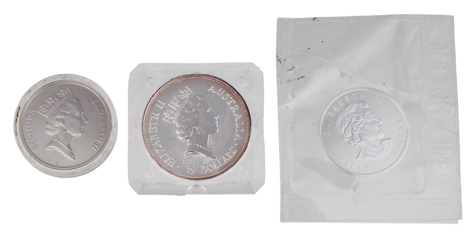 (3) Silver Commonwealth Coins: Three silver Commonwealth coins, to include, one slabbed 1987 $25 Bermuda, 1990 $5 Australia, 2006 $1 Canada Provenance: Property from the Estate of Joy Speck Wilson (1942-2026) from her Menard,