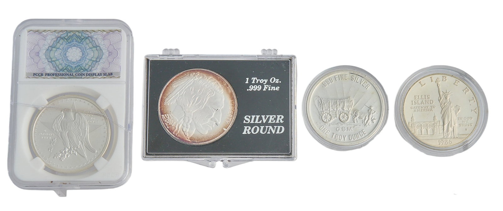 (4) American Silver Coins: Assortment of four American silver coins, each one ounce .999 fine silver, and slabbed Provenance: Property from a home in San Antonio, Texas