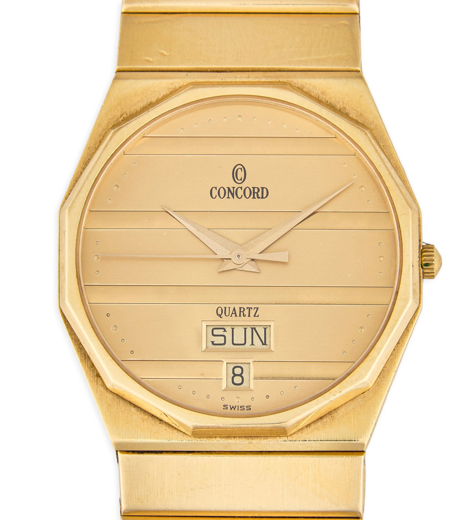 Vintage 14K Concord Mariner Quartz Watch with Day/Date: Vintage 14K yellow gold Concord Mariner wristwatch featuring a champagne dial with horizontal grooved texture, Swiss quartz movement and integrated 14K gold bracelet Length: 7 in. / bracelet