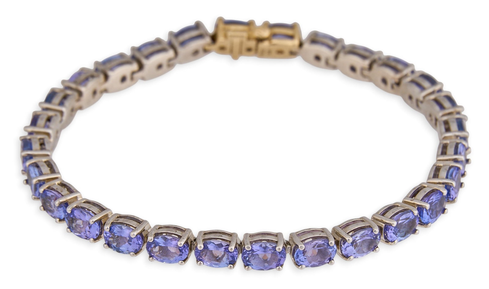 Sterling Silver Tanzanite Bracelet: Sterling silver bracelet set with oval cut tanzanite, 14K yellow gold clasp, marked "925 14K" Length: 7.5 in. Total weight: 15.4 g Provenance: Property from a home in Kingsville, Texas