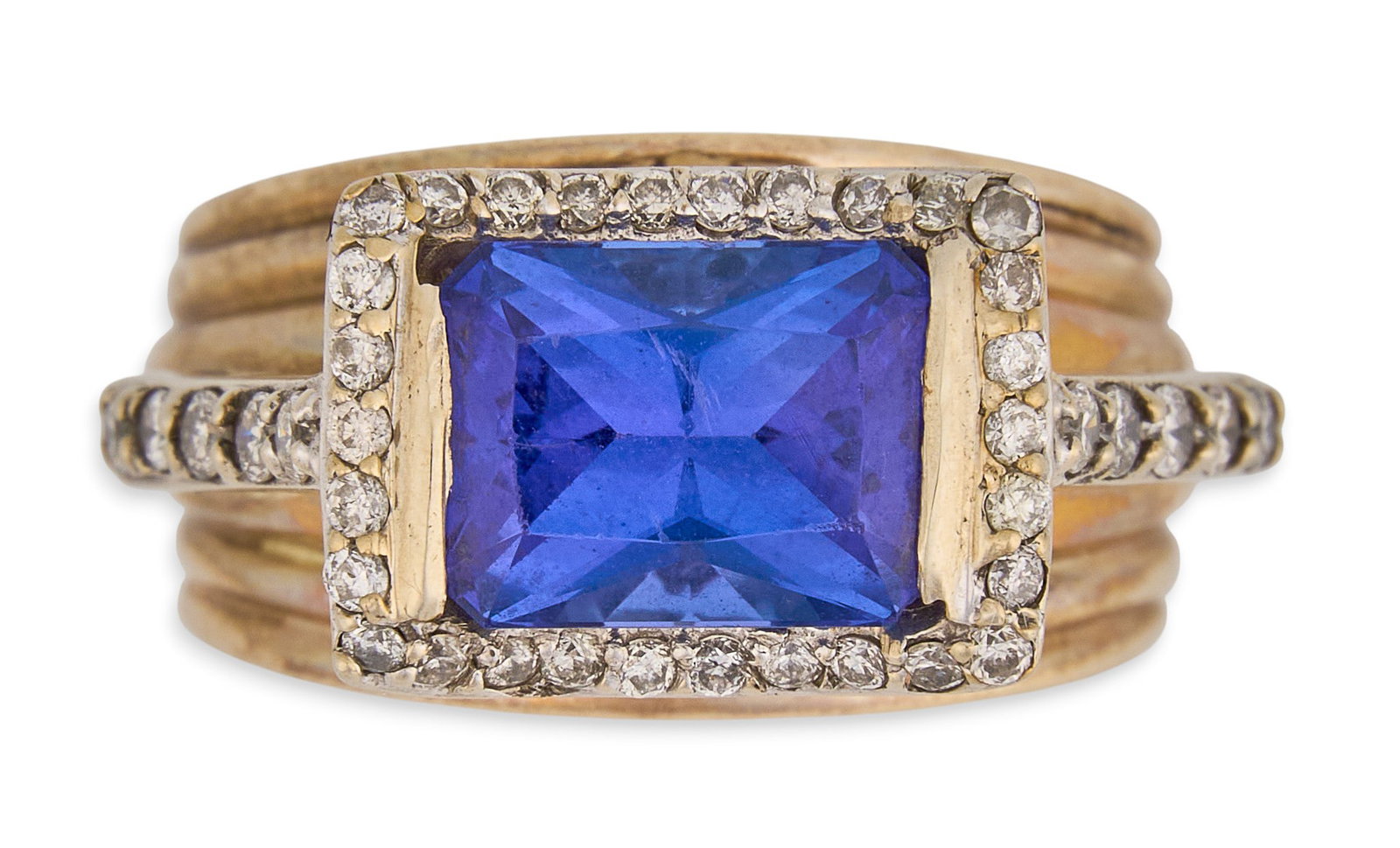 10K Tanzanite & Diamond Ring: 10K yellow gold ring, set with emerald cut tanzanite center stone, approximately 2.96 ct, with round cut diamond details, and filagree design, marked "10K" Size: 6 Total weight: 6.1 g Proven