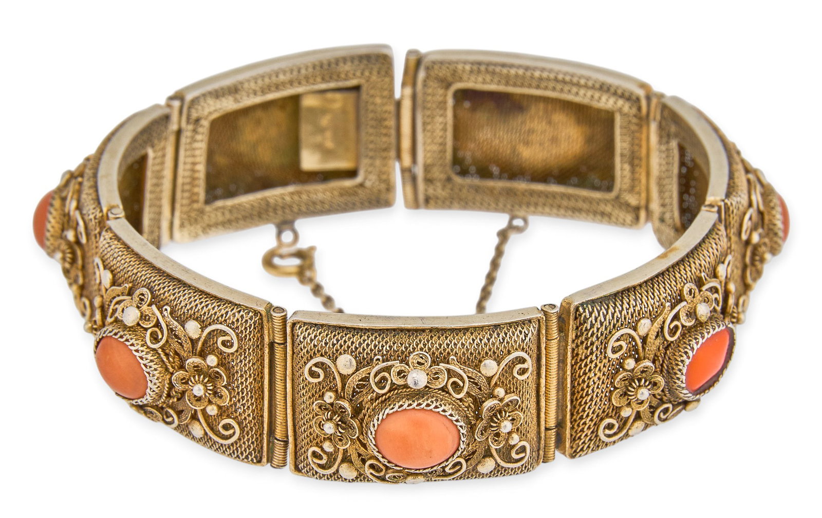 Gilded Silver Filagree Coral Bracelet: Gilded silver filagree bracelet set with coral cabochons, marked "SILVER" to clasp Length: 7.5 in. Provenance: Prope