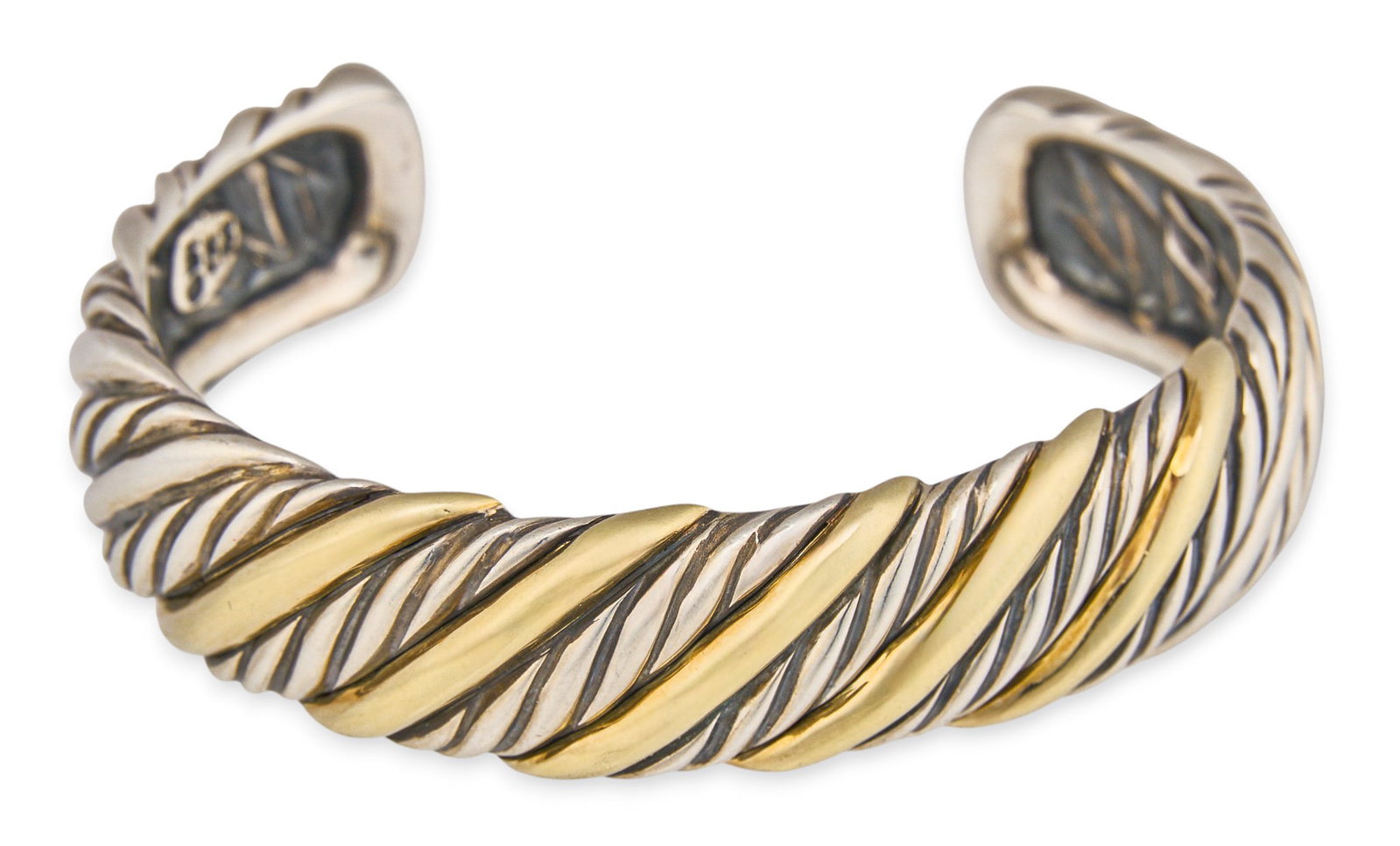 David Yurman Sterling/18K Cuff: David Yurman sterling silver and 18K gold twist cable form cuff, marked "DY 925 750" Circumference: Total weight: 42.2 g Provenance: Property from a home in the Alamo Heights