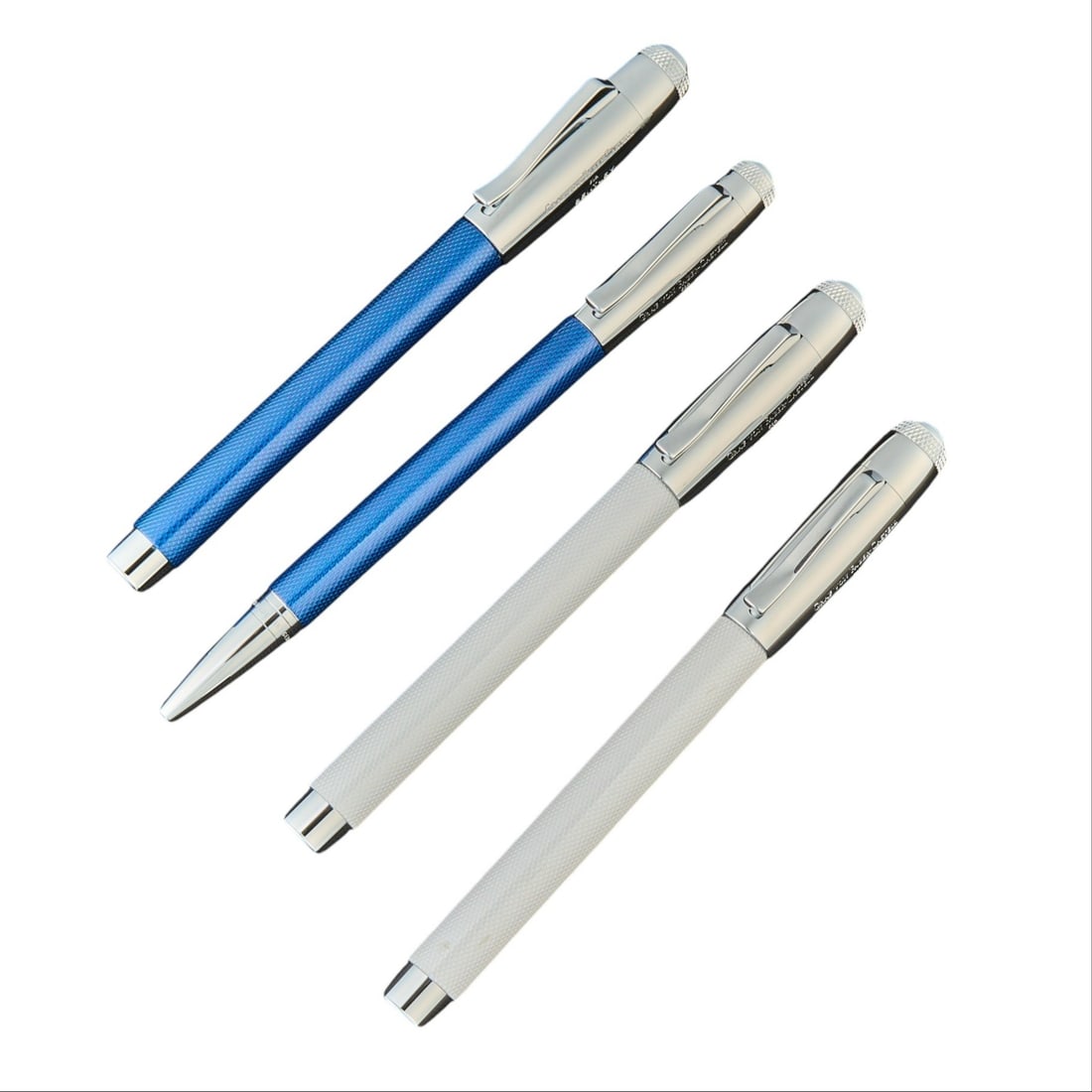 (4) Graf Von Faber-Castell Bentley Pens: Four Graf von Faber-Castell for Bentley writing pens, comprising two blue and two white guilloché-finished examples, each with polished metal mounts, knurled cap finial, pocket clip, and Bentle